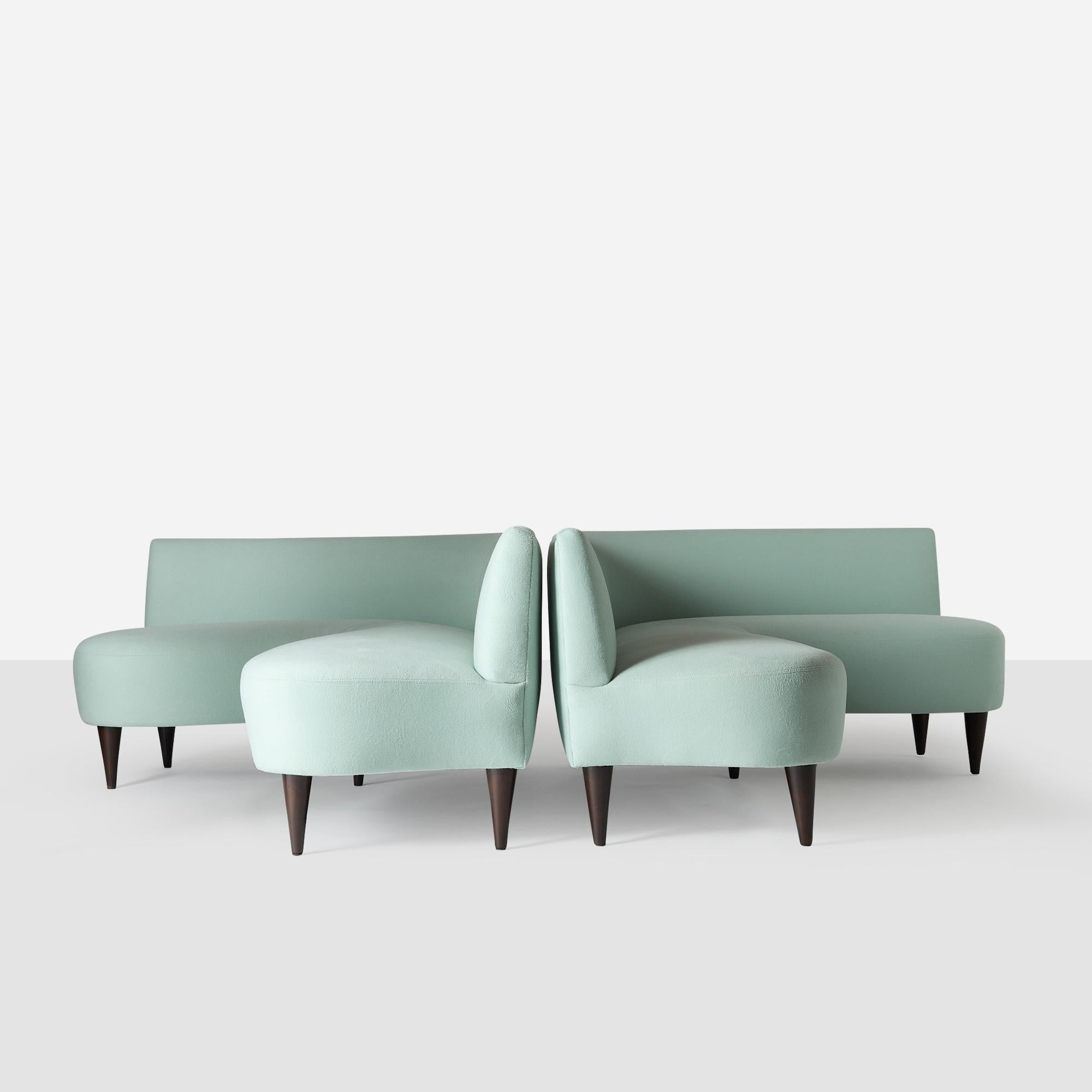 A striking and rare pair of L-shaped sofas attributed to Italian architect and designer Giulio Minoletti. Defined by their low-back profile and sculptural curved edges, these pieces embody a seamless blend of mid-century Italian refinement and
