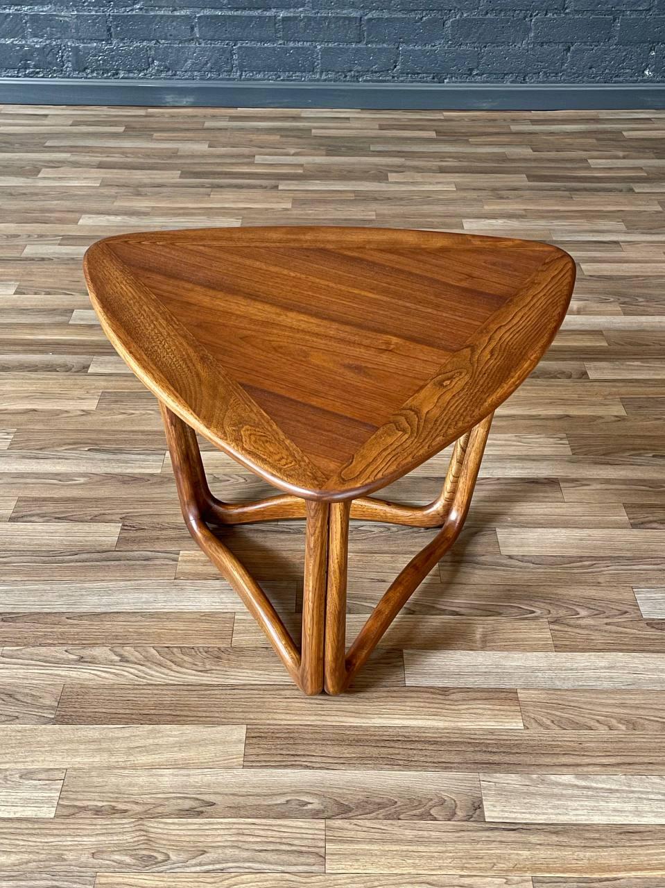 Condition: Expertly Refinished

Crafted by Warren Church for Lane in the 1950s, this expertly refinished “Perception” triangular side table showcases a striking interplay of walnut and oak with a sculptural base that’s as functional as it is