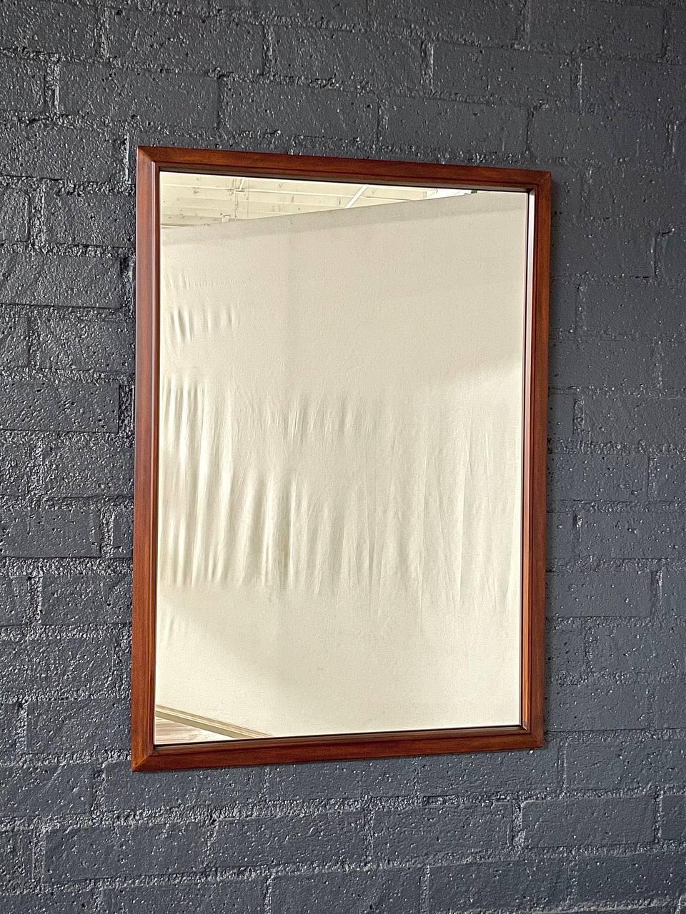 Condition: Expertly Refinished 
Materials: Walnut, Original Mirror

With over 15 years of experience, our workshop has followed a careful process of restoration, showcasing our passion and creativity for vintage designs that can seamlessly be