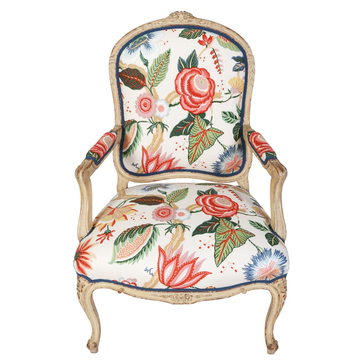 Add a touch of French charm to your space with this beautifully reupholstered Louis XV-style armchair. Featuring a vibrant floral fabric in soft pinks, corals, greens, and blues on a crisp white background, this chair brings a fresh, romantic feel
