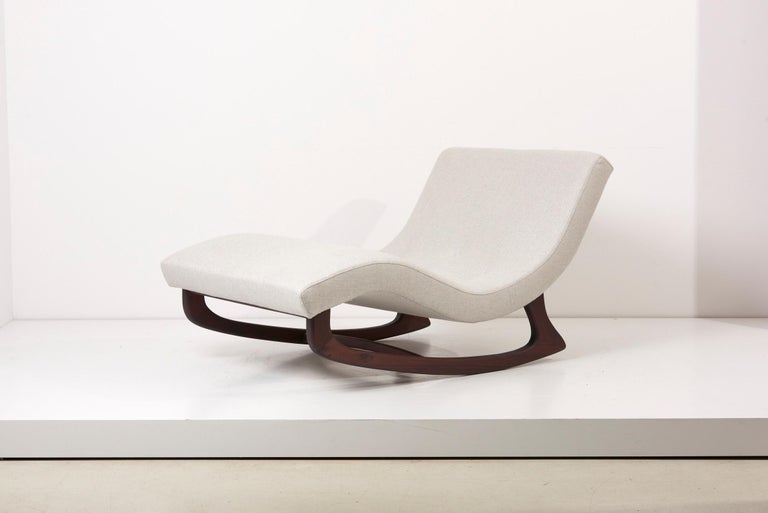 Rare rocking chaise by Adrian Pearsall Rocking with an ergonomic back and new light grey Dedar fabric. While the design is similar to the Pearsall's iconic wave chaise, this model can be distinguished by its sculptural wood base that allows a gentle