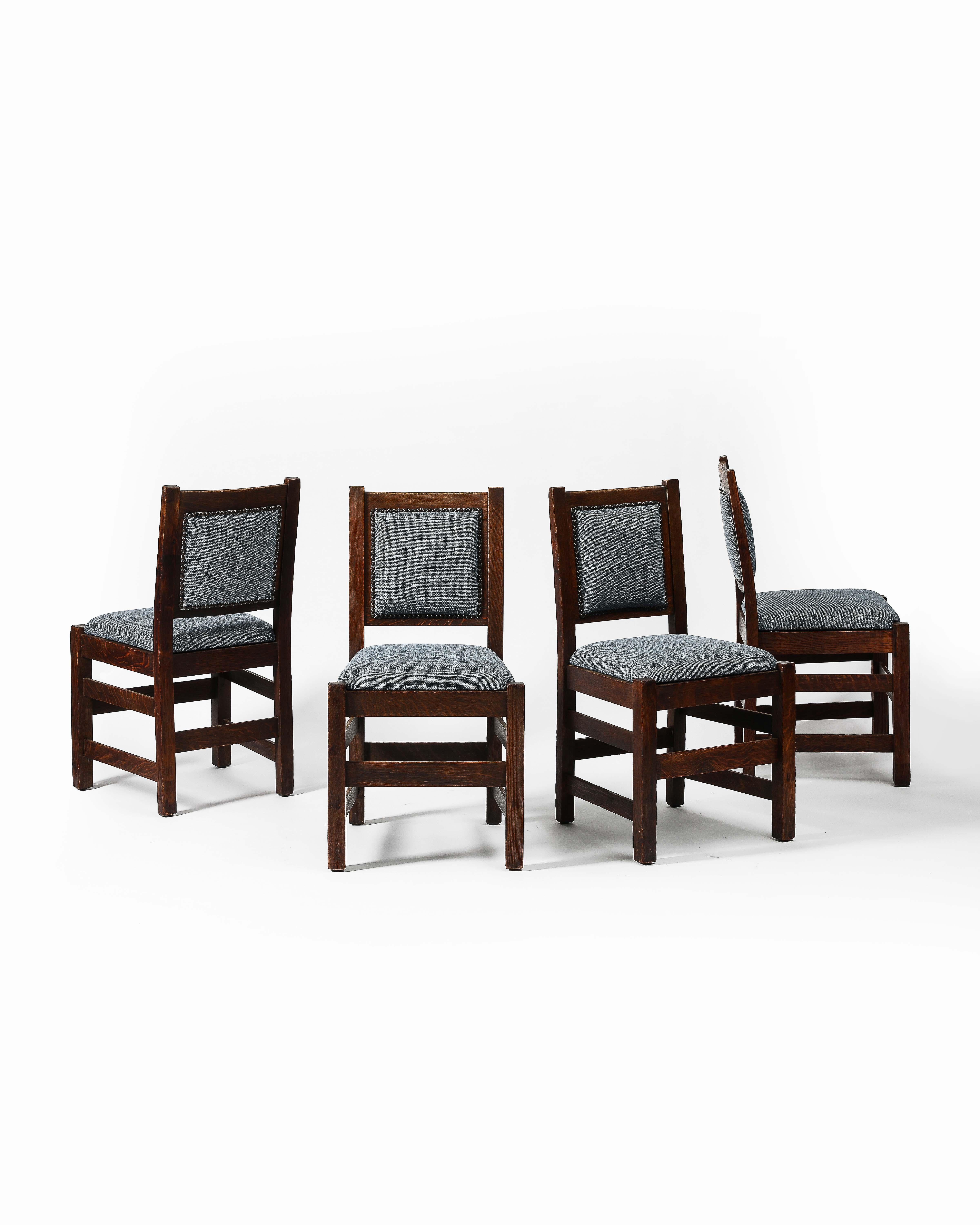 Solid oak arts and crafts style chairs with strong frames and new, petrol blue linen upholstery. 