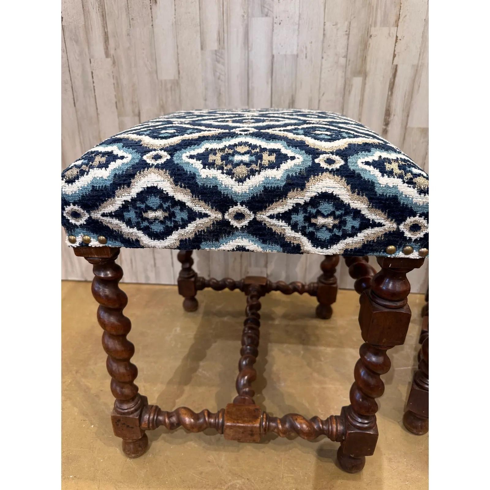 This pair of English barley twist frames have been newly reupholstered! The new fabric is a deep blue accented by white and sage green diamonds with the same blue interiors. The deep colors of the fabric compliment the rich colors of the wood. These