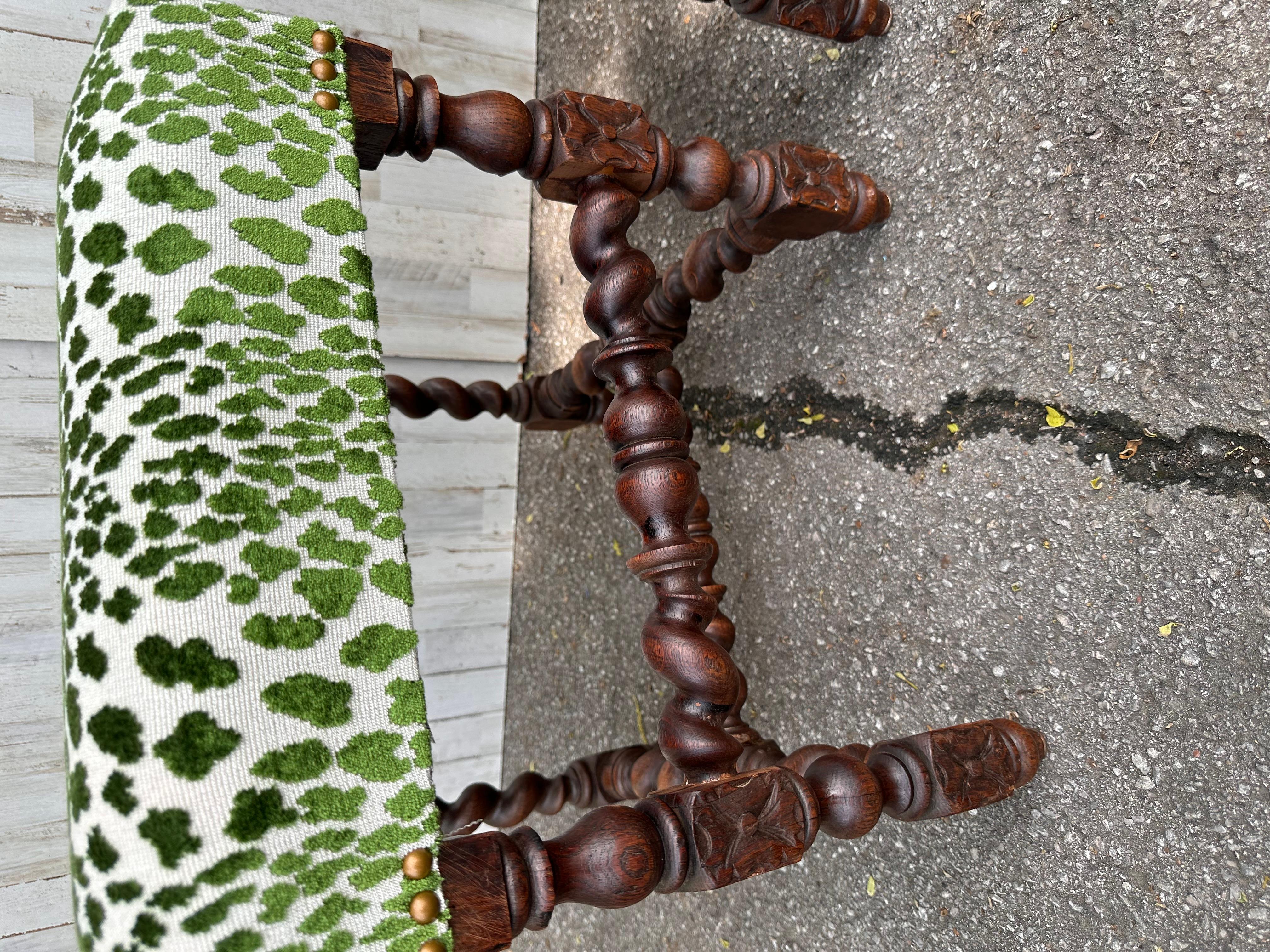 Beautiful antique newly upholstered set of benches! The fabric is a stunning green, crushed velvet material. The base is solid, hand carved wood, rich brown color that pairs wonderfully with the green fabric and brass nail heads. These would look