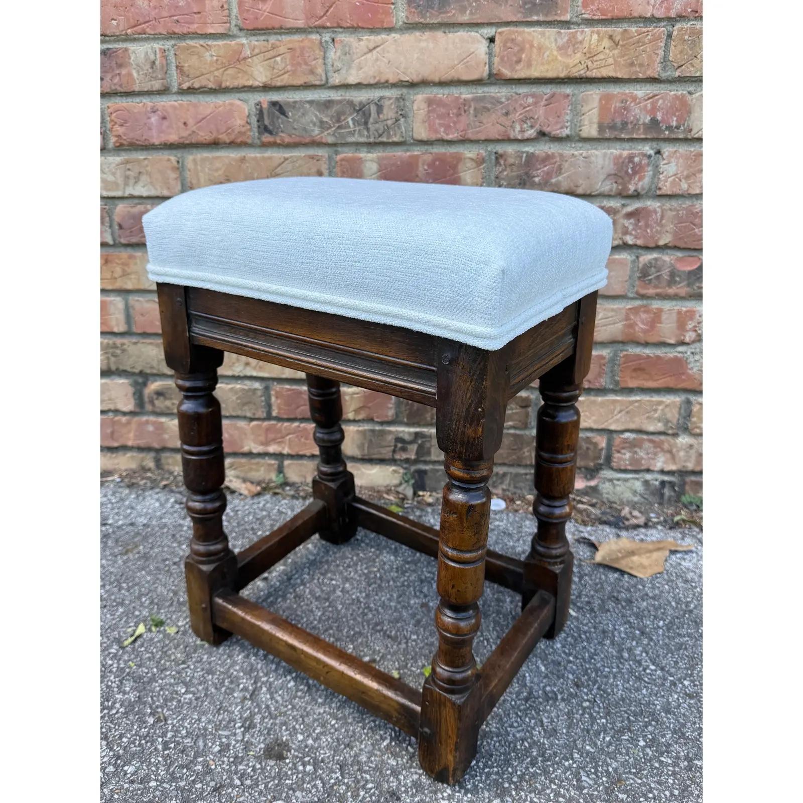 Lovely English Jacobean stool with new fabric and padding. The antique frame is 19th century and fabric is vintage white linen with nailhead trimming. Great accompaniment to any chair or space.
We have match pair of these, but priced individually.