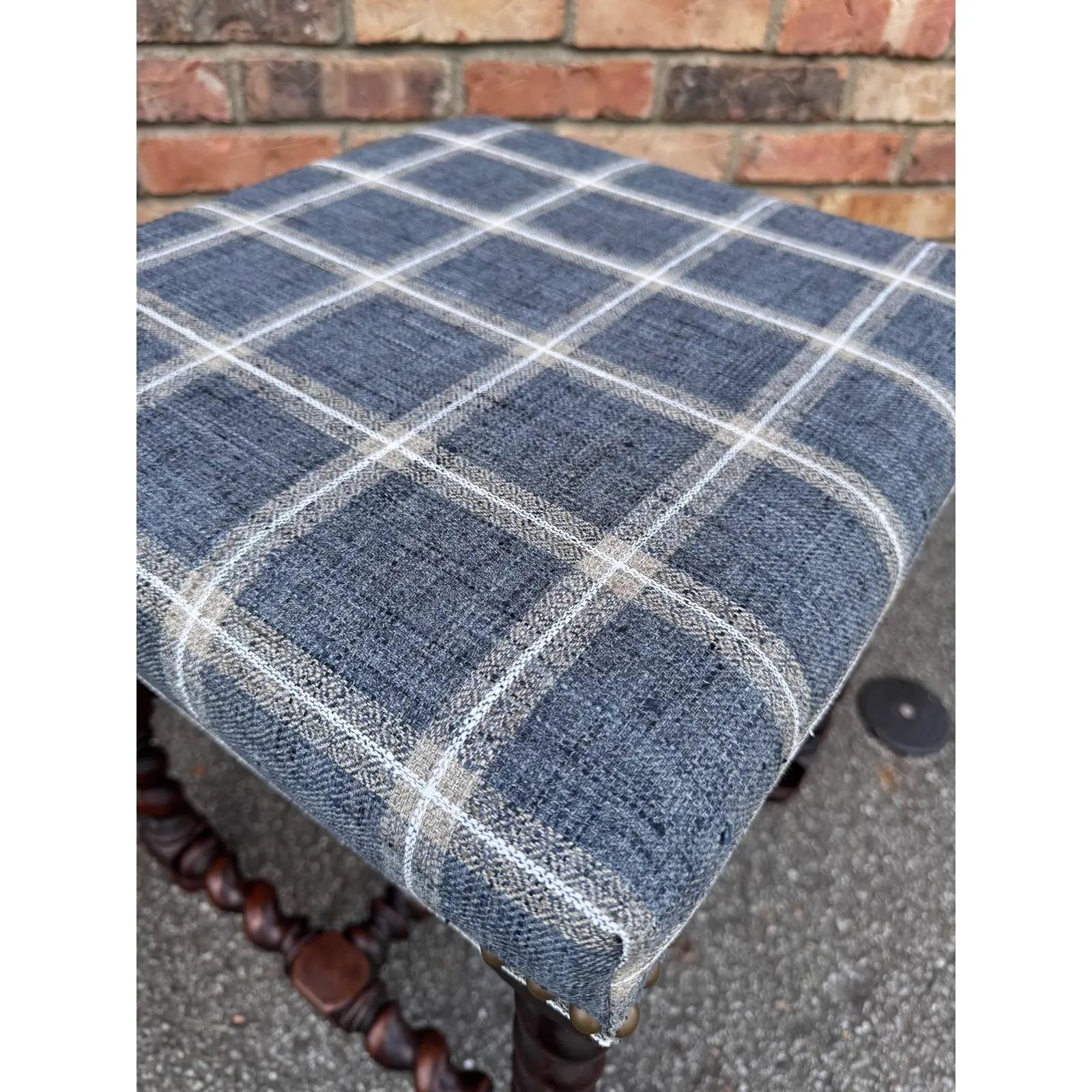 This is such a beautiful pair of plaid stools! The frame is an original English antique, with beautiful turned legs with stretcher bar. The fabric is a blue railroad plaid fabric design that can add depth without being overpowering. See