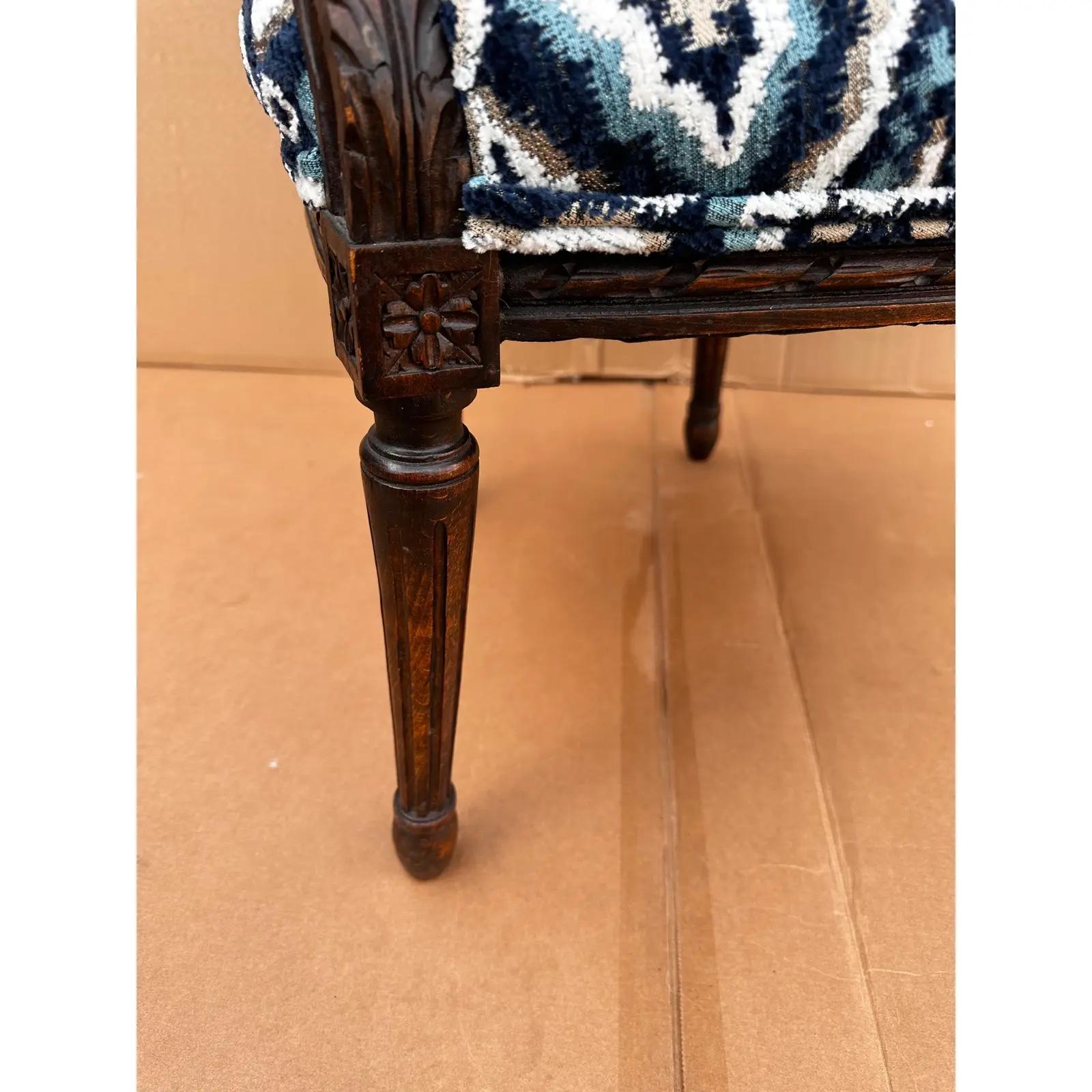 Questa è una sedia francese assolutamente straordinaria! La cornice antica è in legno marrone intenso con dettagli intagliati a mano lungo i bordi e la parte superiore. È stato rivestito di recente con uno splendido tessuto blu scuro e bianco con