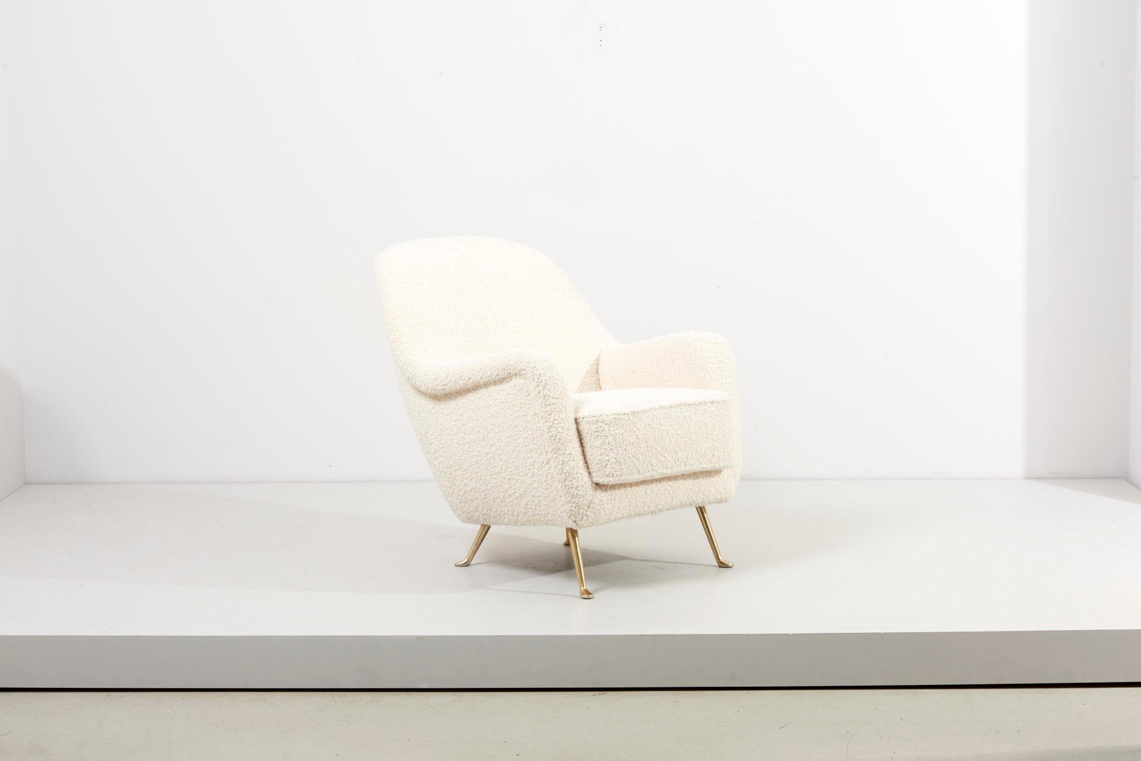 Newly upholstered Lounge chair in white Bouclé. We did a full restoration on this chair. It has also very special legs in solid brass. All the inside was replaced.