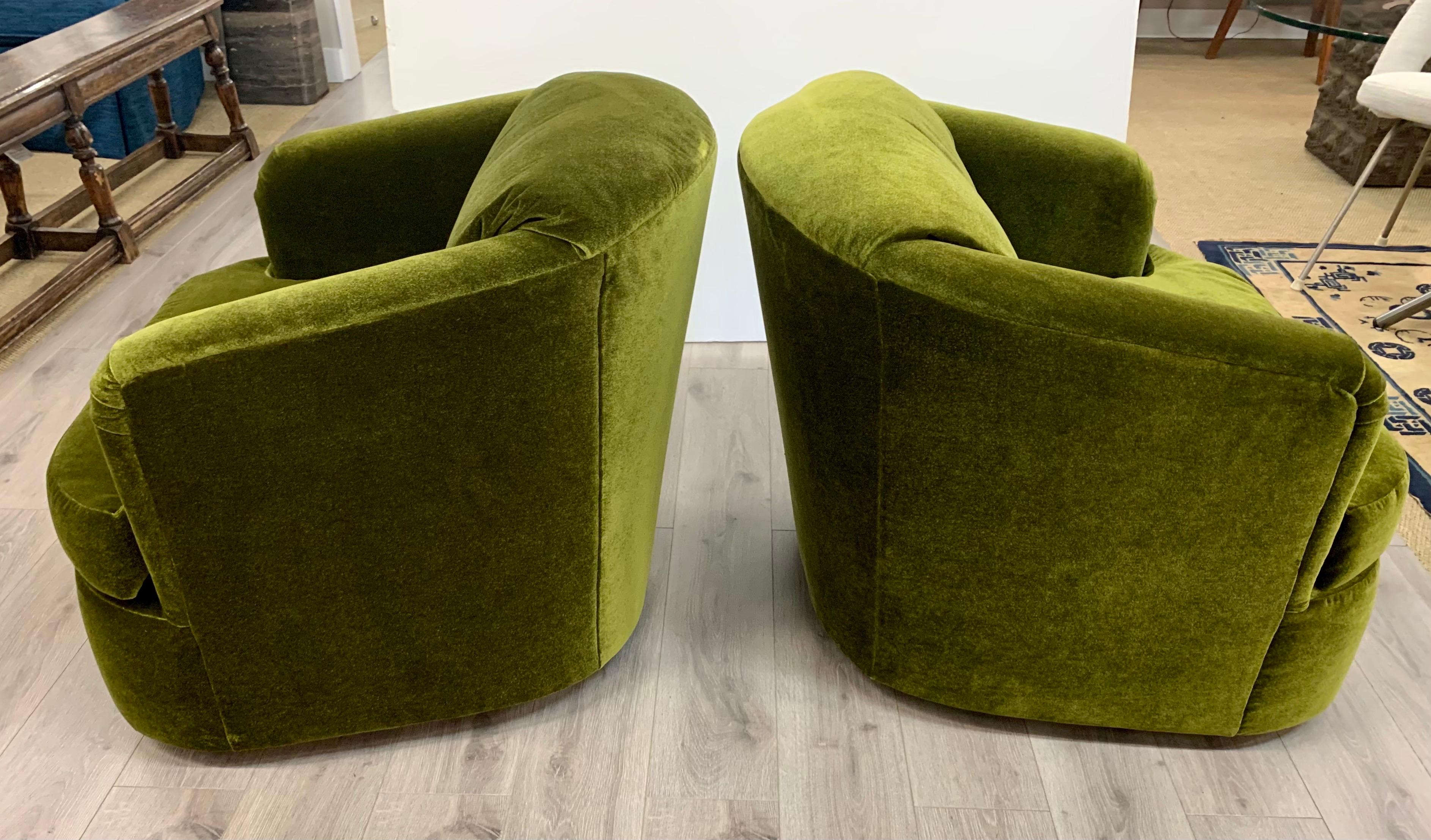 Pair of Mid-Century Modern barrel back swivel chairs with new olive green mohair upholstery.