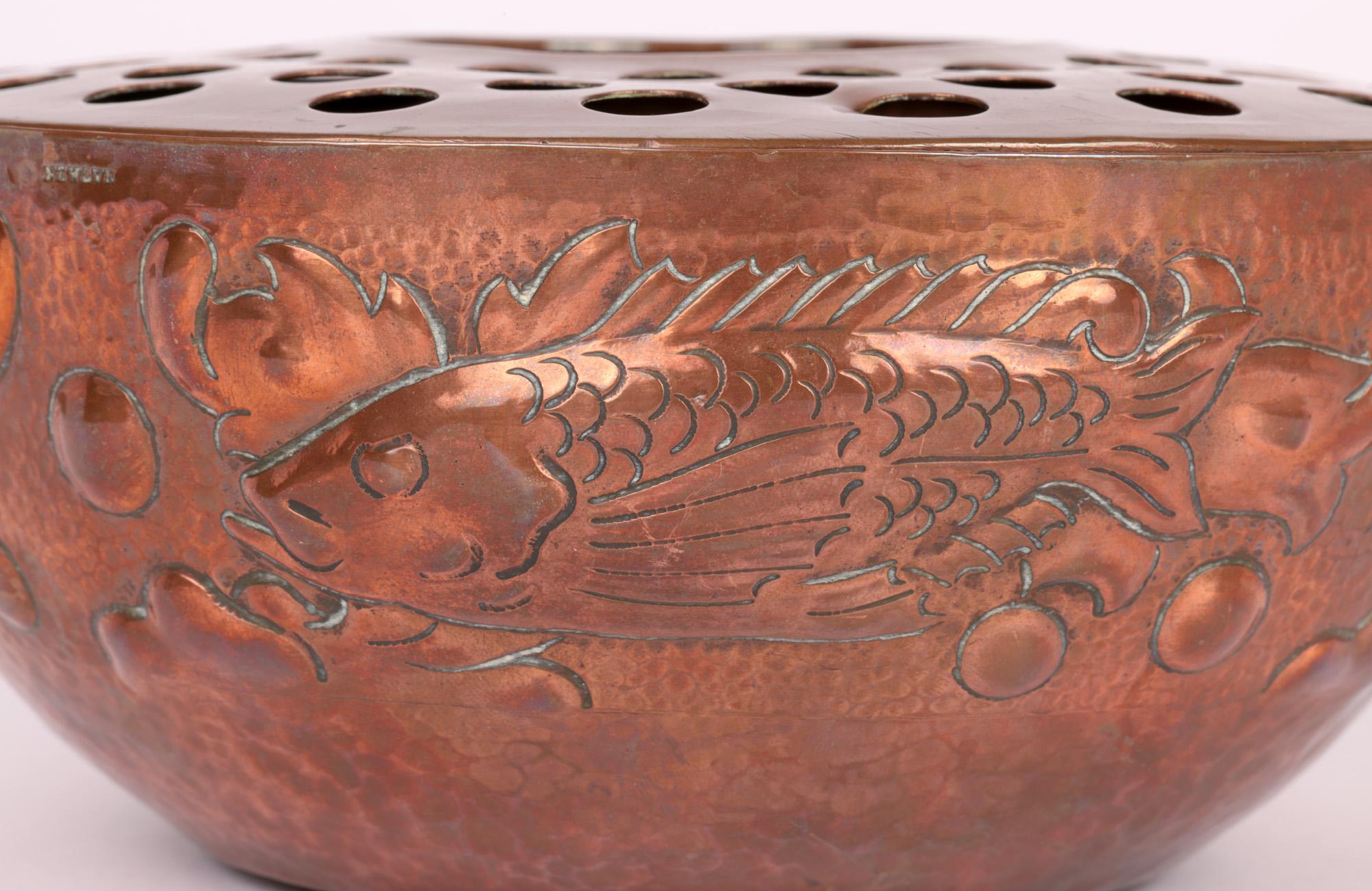 An exceptional English arts & crafts hand crafted copper posy or rose bowl decorated with fish made by renowned Cornish copper workshops Newlyn and dating from around 1900. The bowl has a hand planished finish with a narrow round shaped foot with
