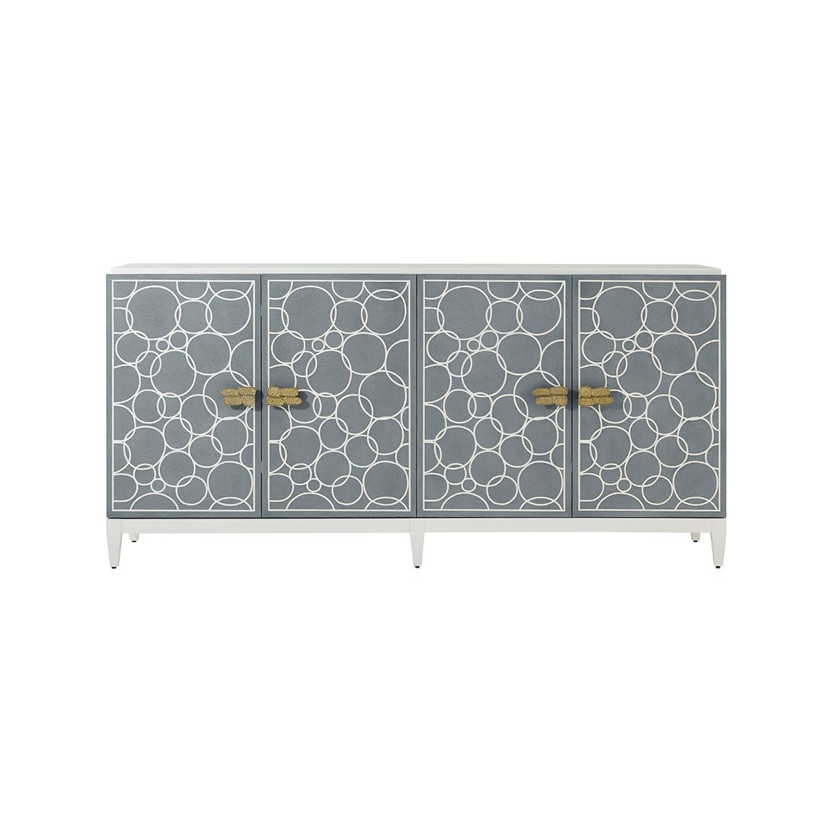 In our White Dove lacquer finish is designed to be a statement piece. With four faux shagreen embossed leather doors in our Sea Foam finish are paired with a polished hammered aluminum handle. Adjustable shelving is included on a short tapered
