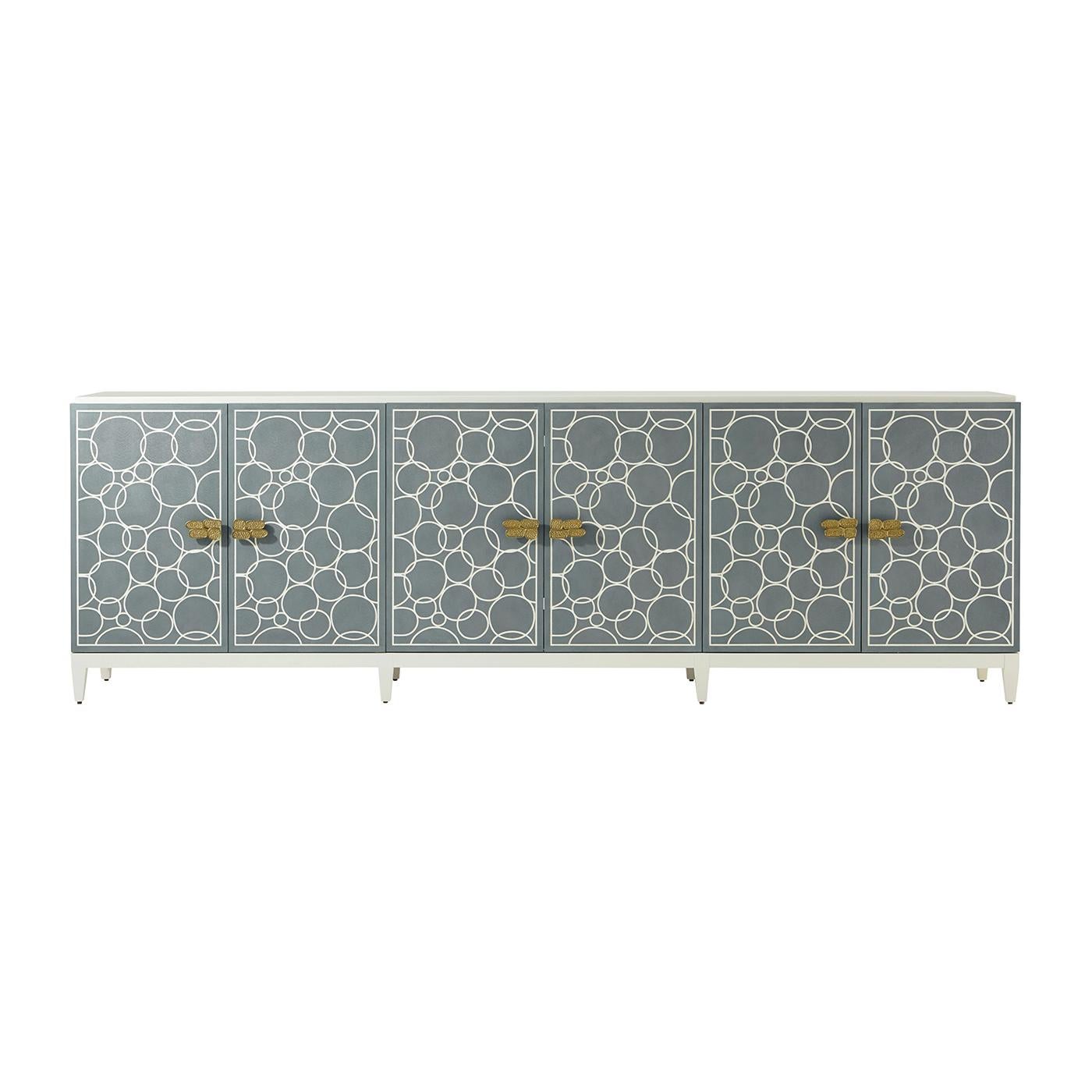 The sideboard cabinet seen in our White Dove lacquer finish is designed to be a statement piece. With six recon shagreen embossed leather doors in our Sea Foam finish are paired with a polished hammered aluminum handle. Adjustable shelving is