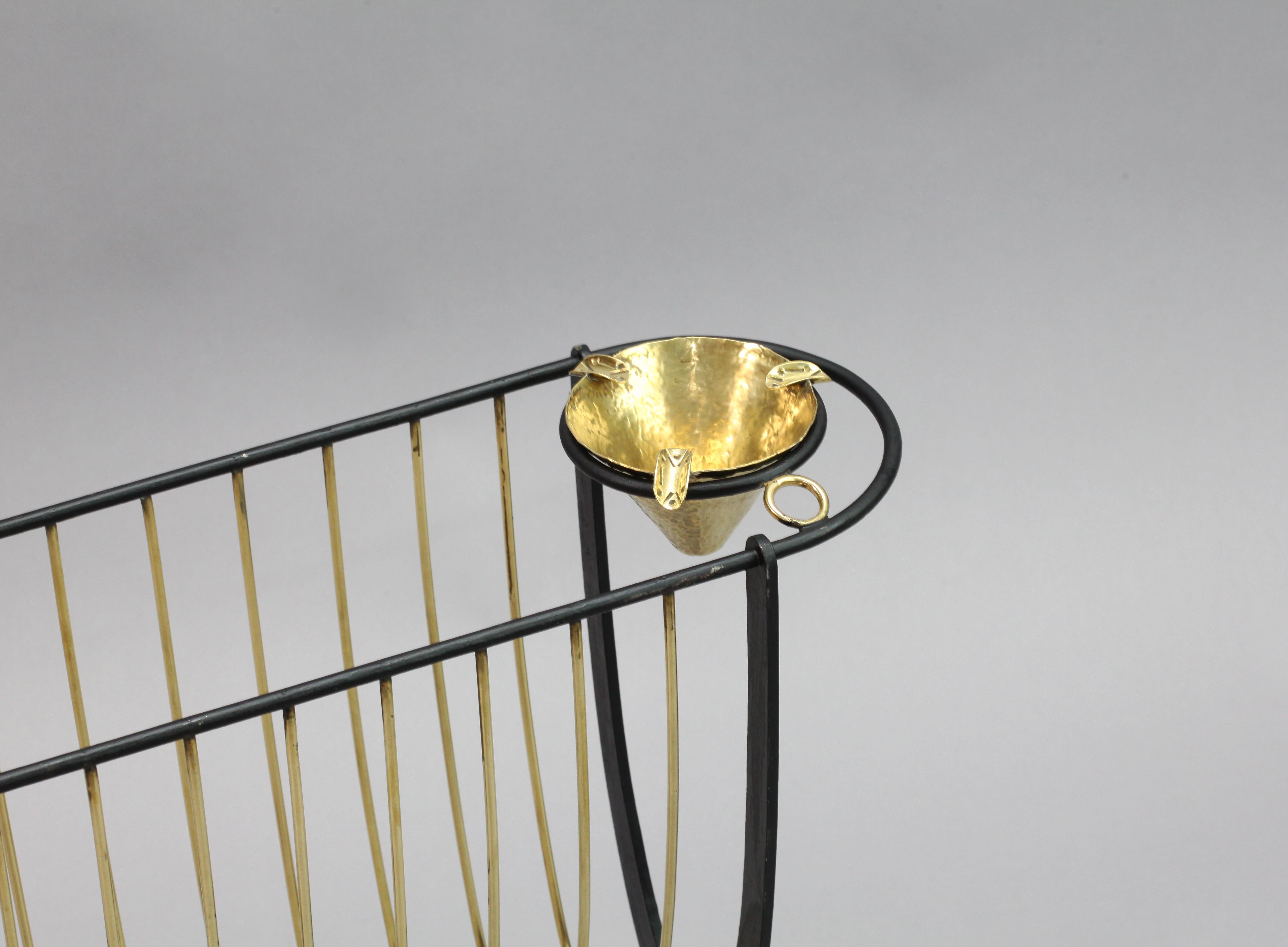 newspaper rack with ashtray,
Italy 1950.
black laquered metal, brass ashtray.
