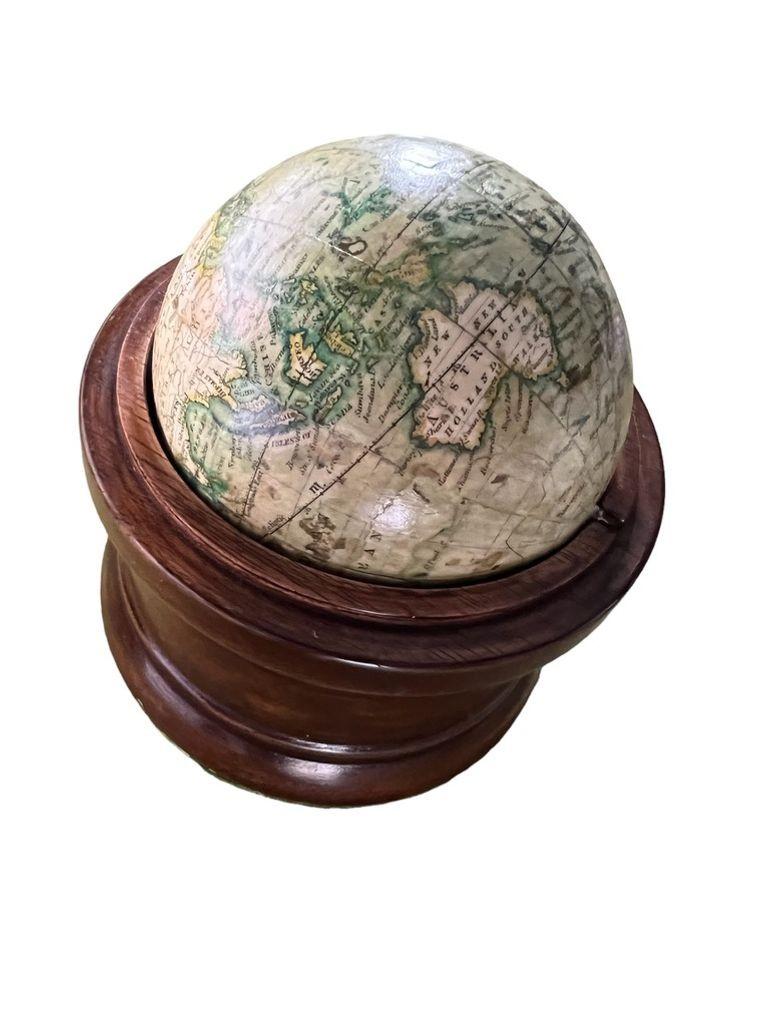 The terrestrial globe is 3 inches in diameter contained within a turned mahogany box with cover. The seas in light green and land masses in darker green.
Dimension of Globe 3