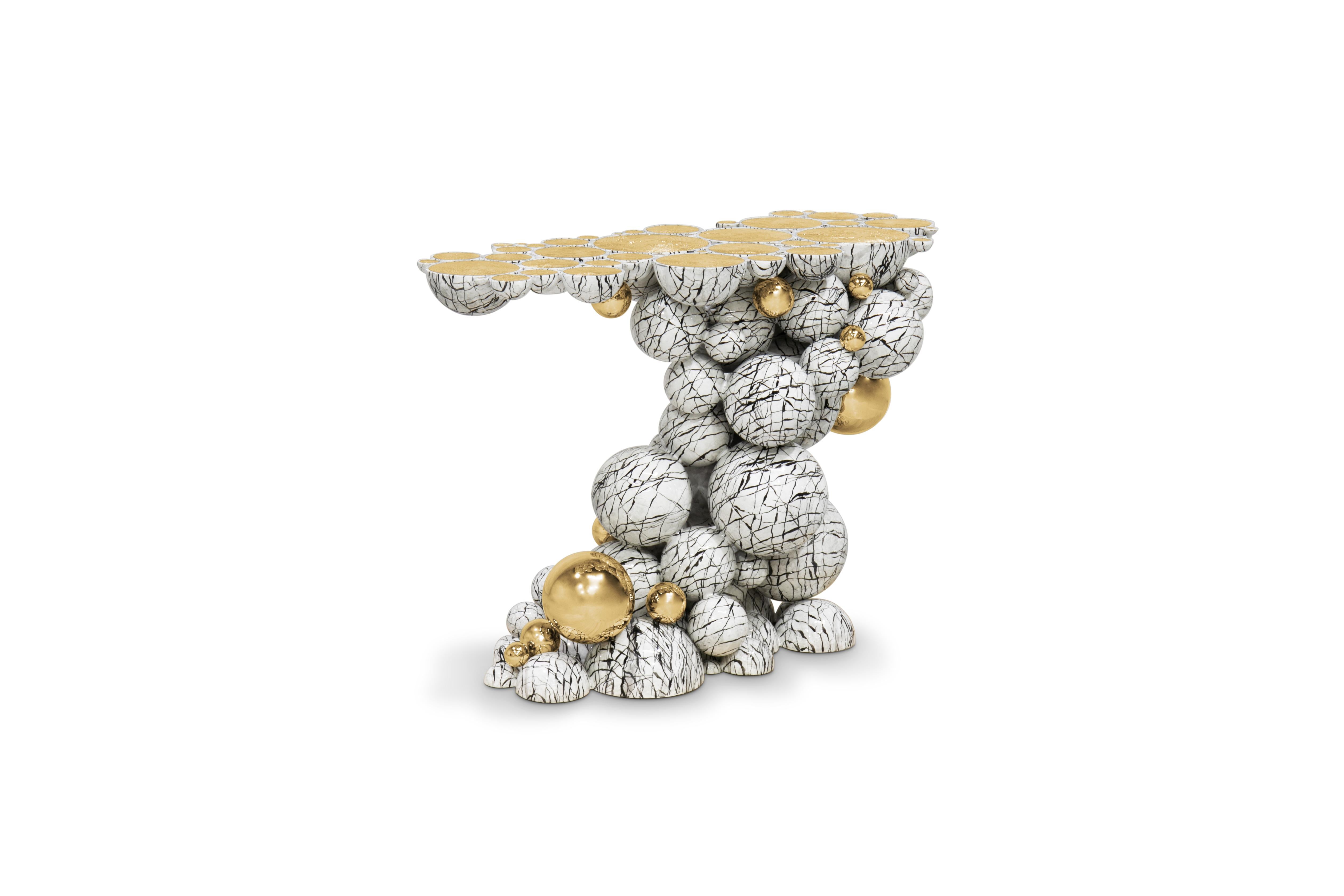 Defying the laws of physics, the Newton console has grown from the ancient art of casting metal, where metal is heated until molten into spheres and semi-spheres shape. One by one, each element is joined to produce an outstanding pattern and organic