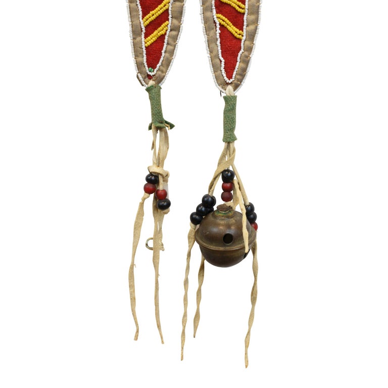 Early designed beaded Nez Perce martingale. Constructed stroud applied to canvas with beaded panels of hourglass and diamond motifs. Split tab and brass bell suspensions. Stunning piece!

Period: 19th century

Origin: Nez Perce, Idaho

Size: 16” x
