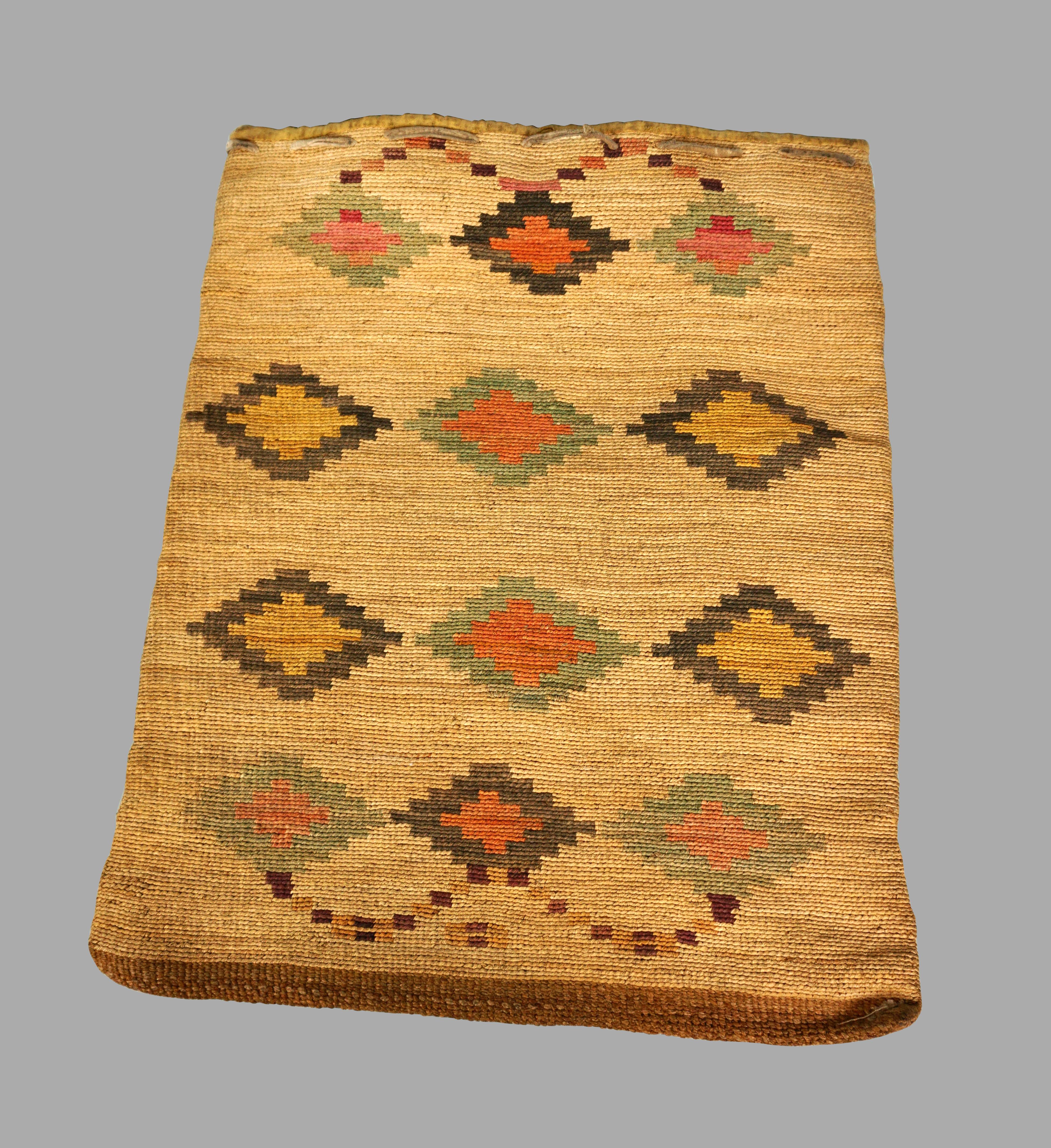 A Nez Perce cornhusk bag of typical form, circa 1880. Cornhusk bags of flat form were unique to the Columbia Plateau area in Oregon. They were made by the Nez Perce, Yakama, Cayuse, Palouse and Walla Walla people. Nez Perce weaving such as the