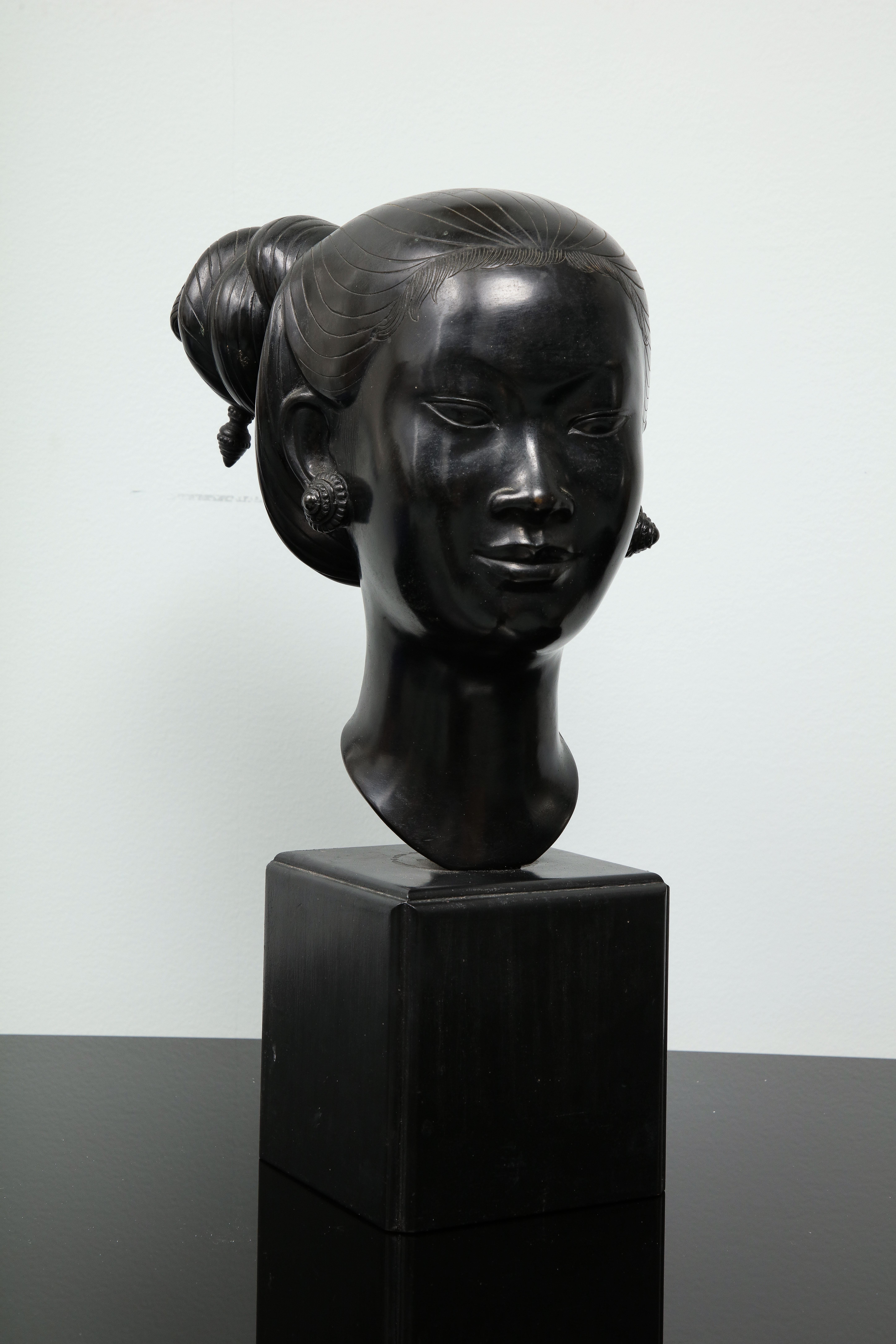 Nguyễn Thanh Le (1919-2006) was a Vietnamese painter and sculptor. This bust of a young Vietnamese woman is black patinated. It stands on its original wooden cube base. The sculpture is signed in Chinese characters on the back of the neck.
