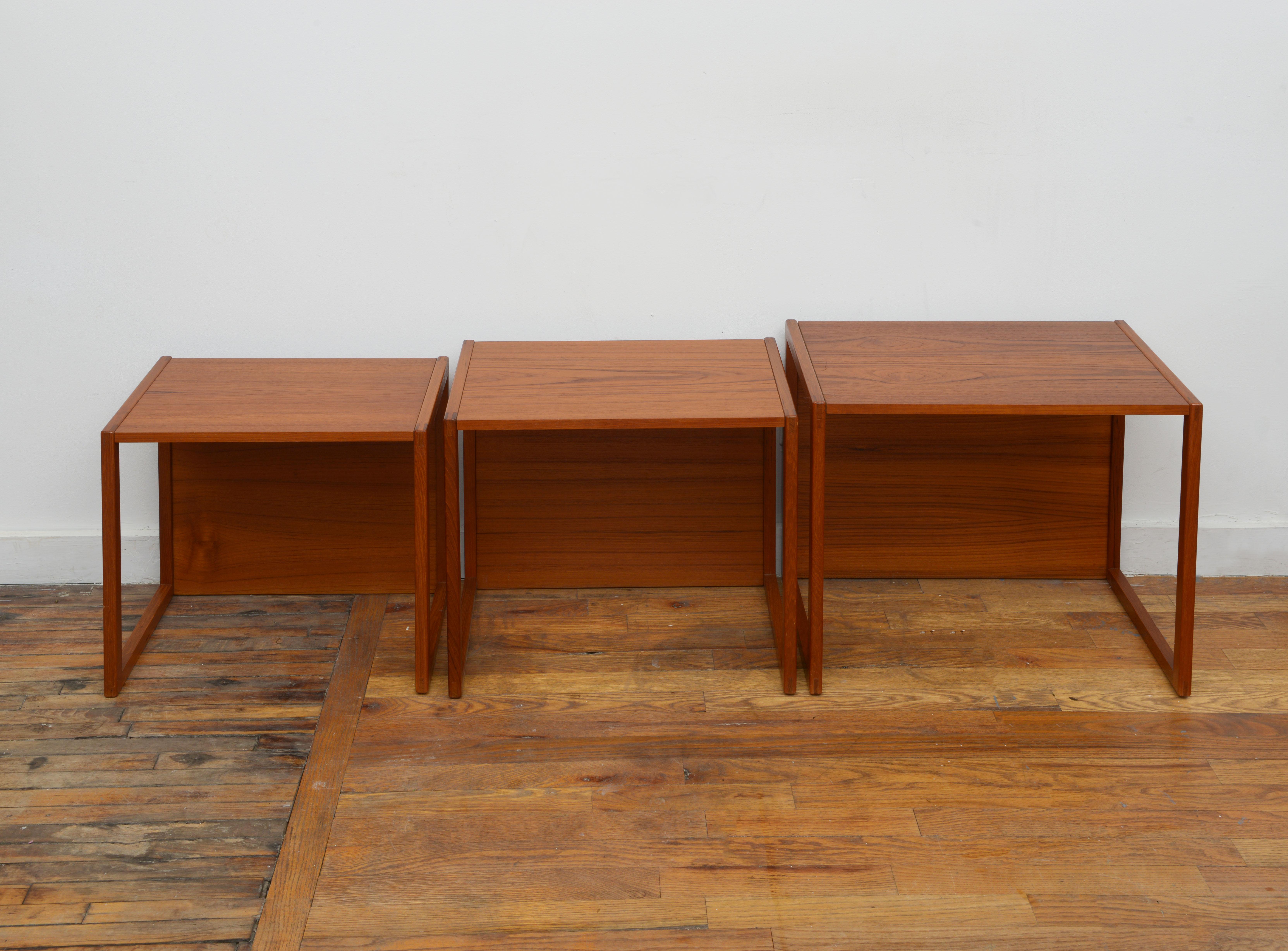 A beautiful set of 3 Danish modern nesting tables by NH Collection 1960s. Signed with label and made in Denmark stamp on underneath one of the tables. These tables feature an interesting design with a top and backside fully covered in teak. They can