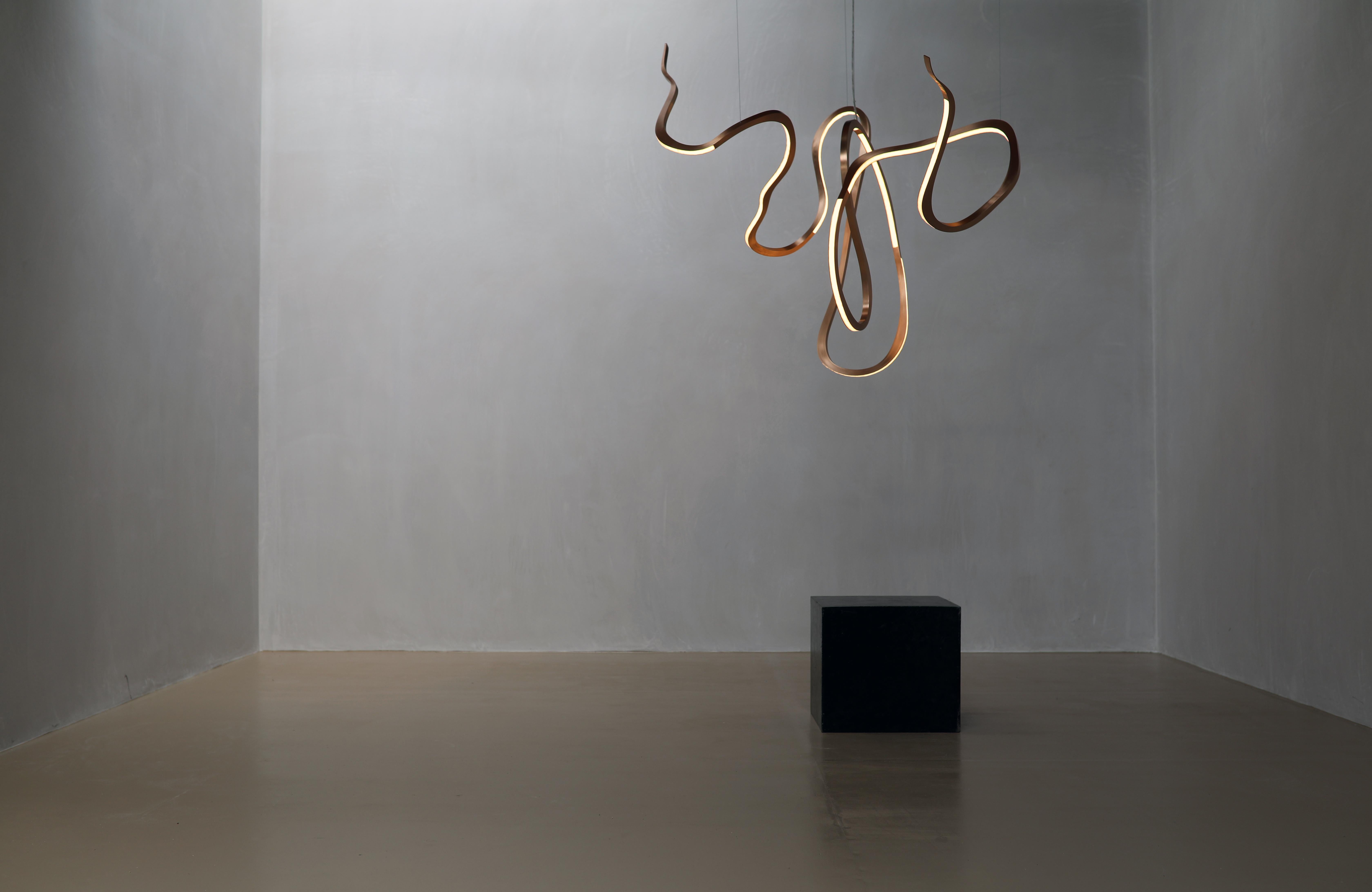 As with her previous iterations of Artist's Hand, Niamh Barry once more shows her mastery in conveying beautiful forms of movement with polished bronze and LED. In this case the Irish artist, employing elements relatively new to her work (like a