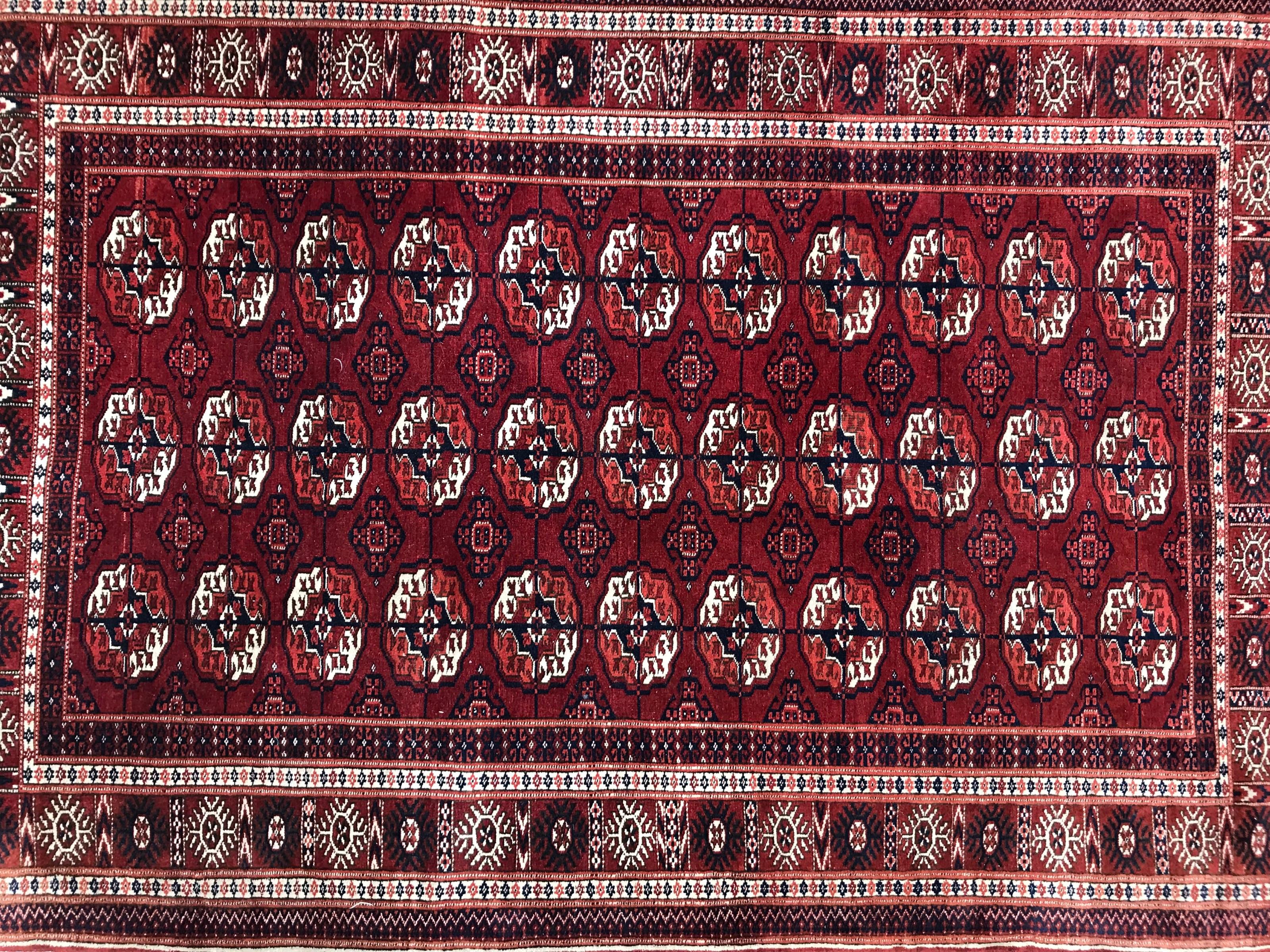 Very beautiful late 20th century Turkmen Afghan rug with a nice boukhara design with beautiful boukhara Guls and geometrical design, and beautiful colors with red, orange, dark blue, green and black, entirely and finely hand knotted wool velvet on