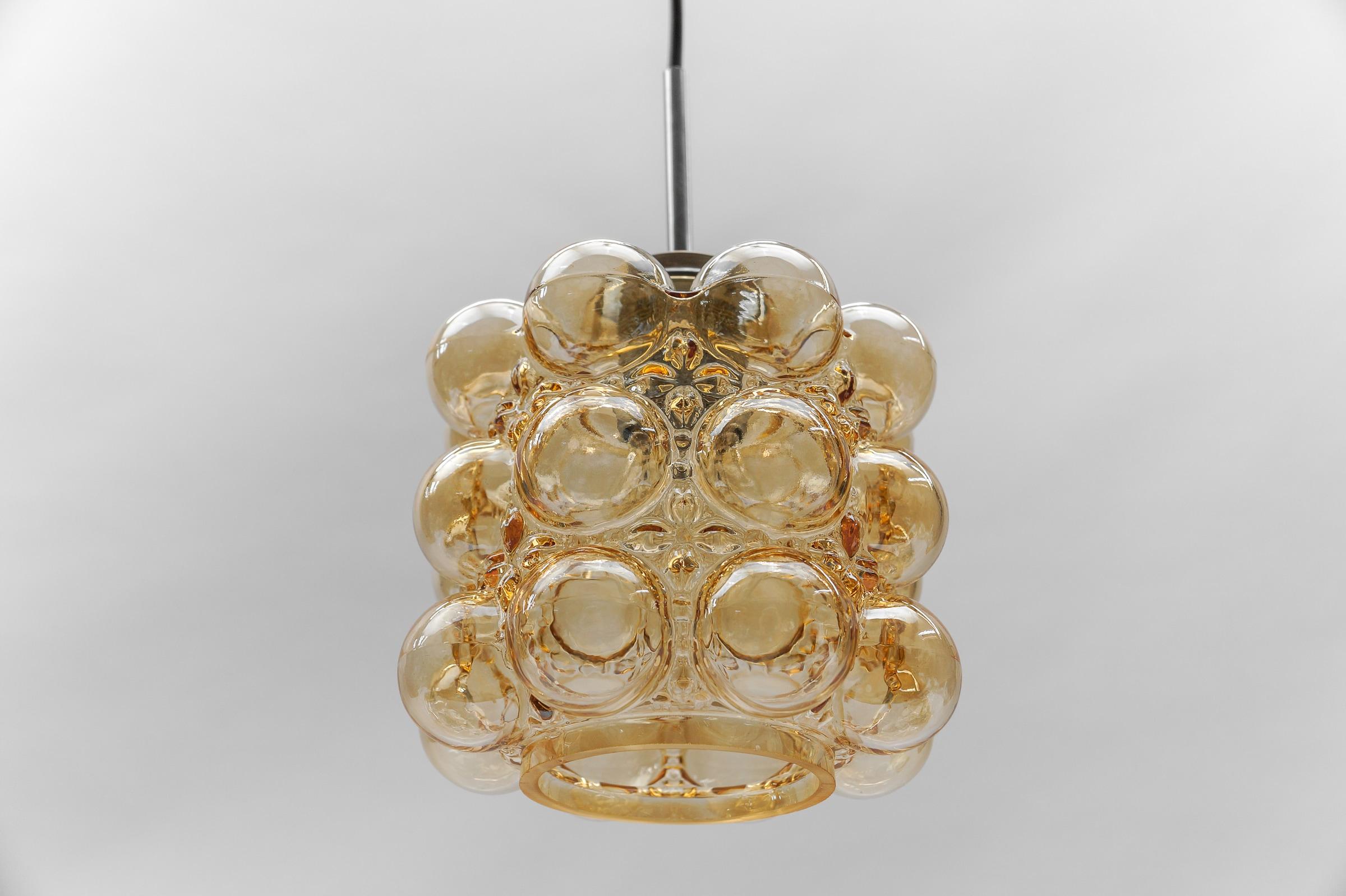 Amber Bubble Glass Ceiling Lamp by Helena Tynell for Limburg, Germany 1960s

Dimensions
Height: 23.62 in. 85 cm)
Diameter: 9.44 in. (19 cm)

The fixture need 1 x E27 standard bulb with 60W max.

Light bulbs are not included. 
It is possible to