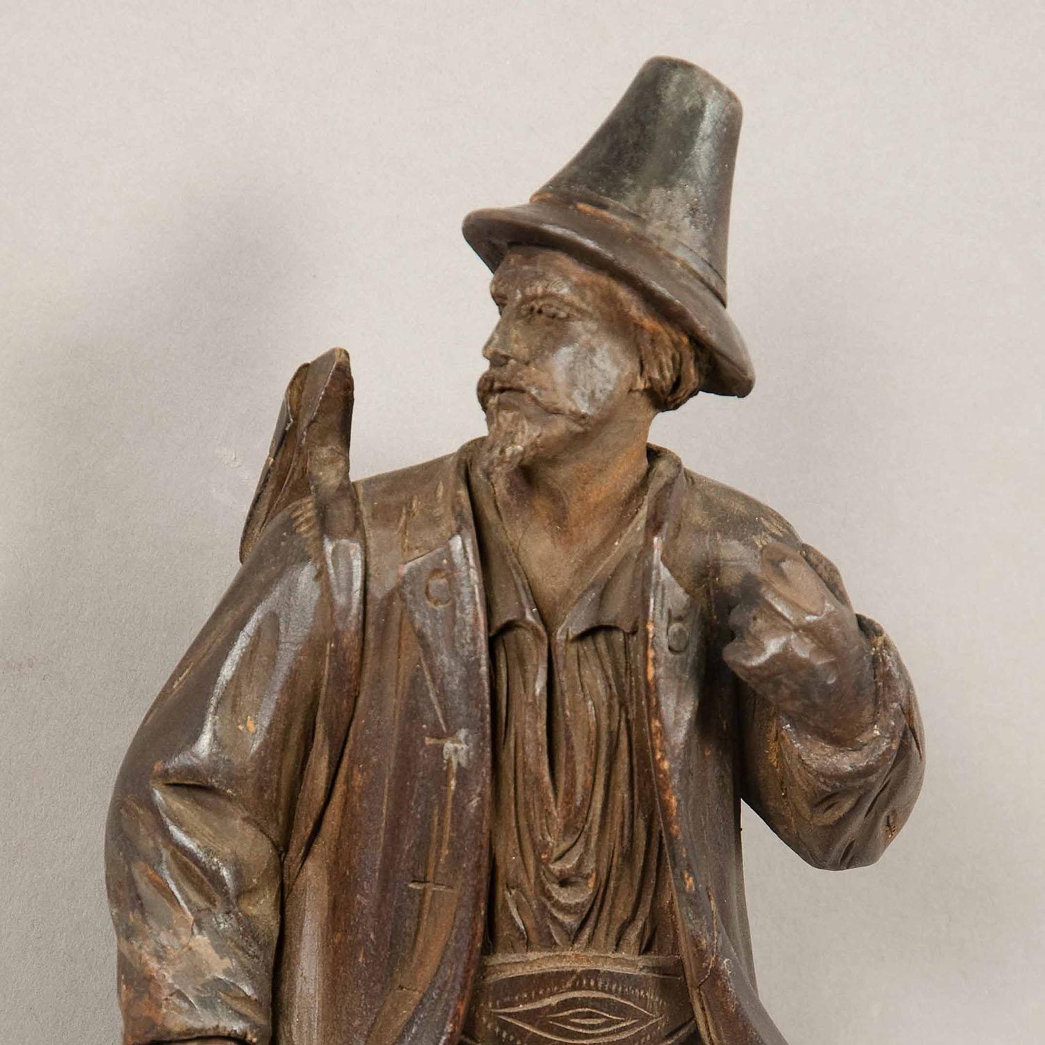 A nice hand carved wooden Black Forest whip holder / coat hook depicting a hunter with his gun. with two real chamois horns mounted as hooks. executed in swizerland or Austria circa 1890.

Measures: Width 3.94