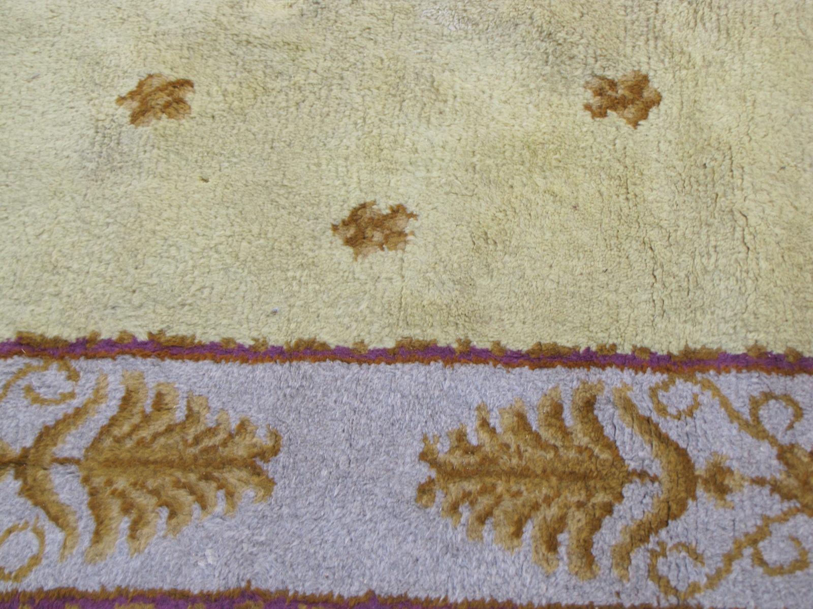 Beautiful French Savonnerie rug with a Louis XVI style design, early 20th century with nice yellow field and purple colors, entirely hand knotted with wool velvet on cotton foundation, good conditions.