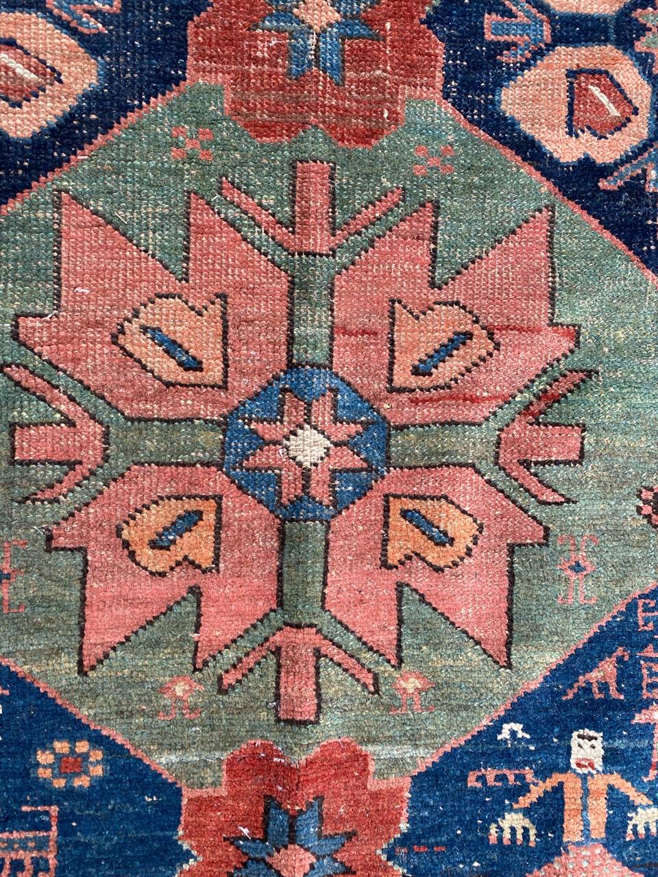 Very beautiful late 19th century tribal rug with a geometrical design and beautiful natural colors with orange, red, blue, green and pink, entirely hand knotted with wool velvet on wool foundation.