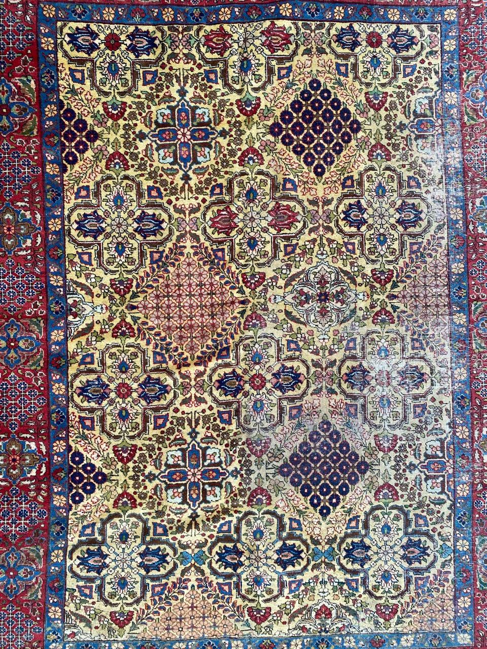 A captivating early 20th-century rug, a testament to timeless artistry. This masterpiece features a decorative design and vibrant colors – yellow, blue, green, red, and pink. Entirely hand-knotted with wool velvet on a cotton foundation, it boasts