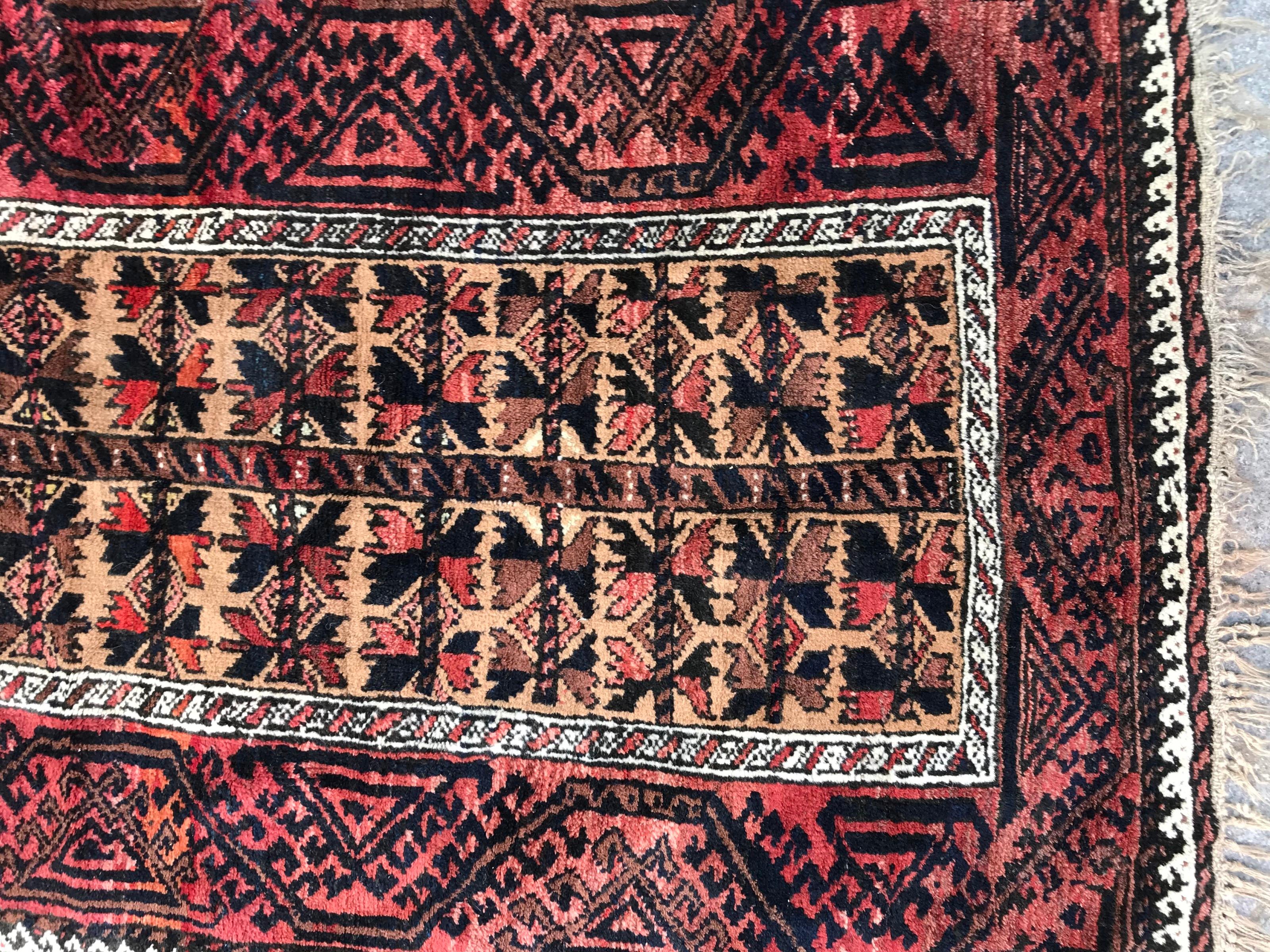 Beautiful early 20th century Turkmen Baluch rug with a tribal geometrical design and natural colors, with red, brown and yellow colors with orange, red, brown and black, entirely hand knotted with wool on wool foundation. Size: 2ft 11.44 inch x 5ft