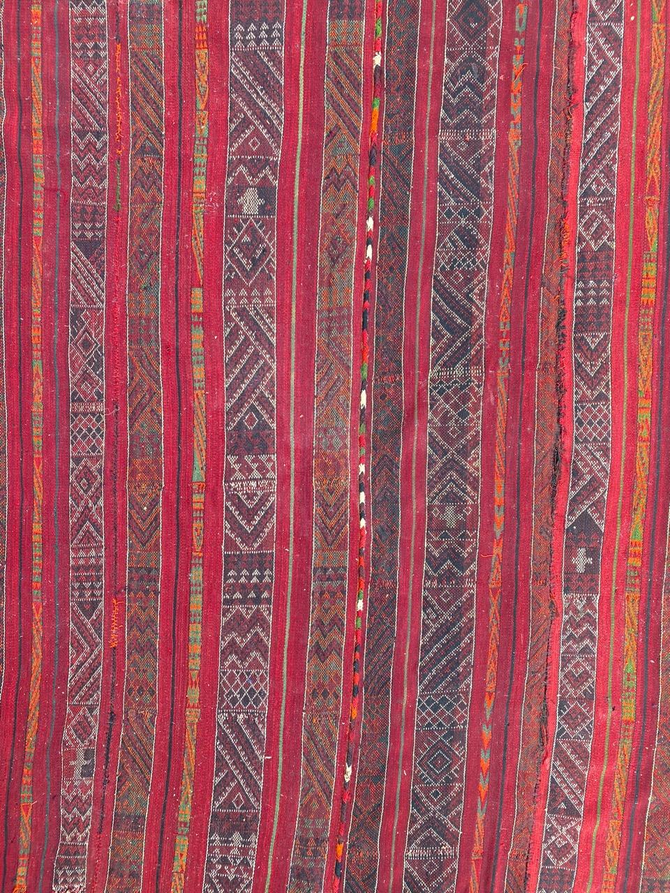 Beautiful early 20th century long tribal Kilim made by assembling of strips of Kilims, with tribal design and nice natural colors, entirely hand woven with wool on wool foundation.