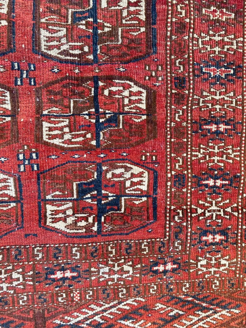 Beautiful little Afghan Boukhara rug with a tribal Boukhara design and red, blue and brown colors, entirely hand knotted with wool velvet on wool foundation.