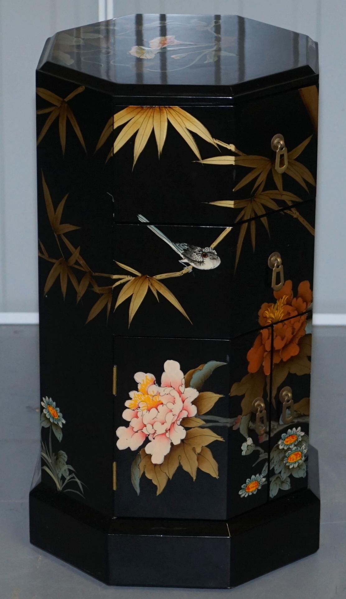 We are delighted to offer for sale this ornately decorated Asian lacquered and hand painted side table or work box

A good decorative piece, it can be used as a side table or work box, the drawers are lined with red baize

I can't see anything