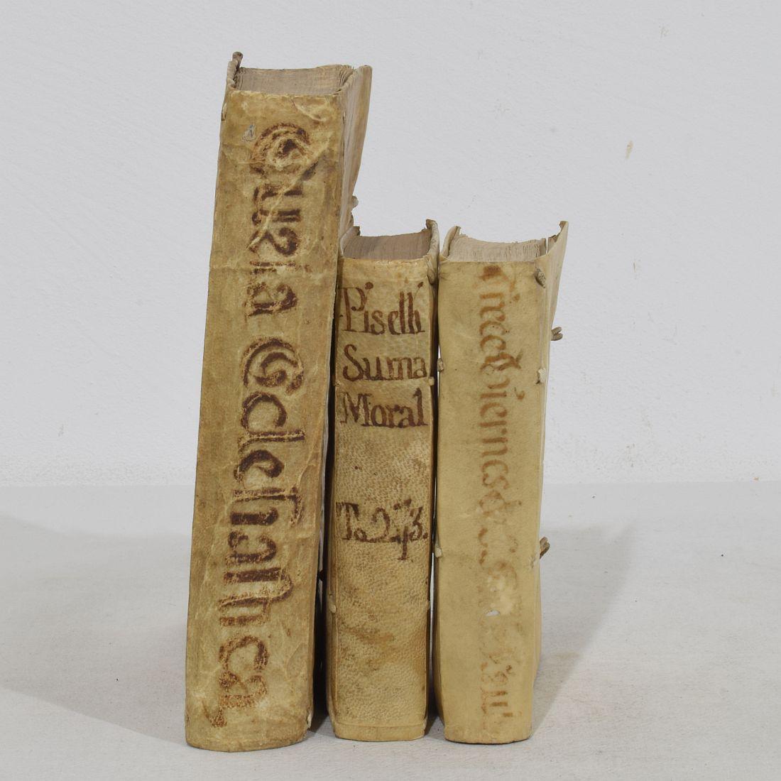 Nice collection of three extremely weathered vellum books, Spain/ Italy 18th century. Weathered and small losses
Measures: H:15-20cm  W:3-4cm D:9-16cm 
Measurements here below of the largest book.