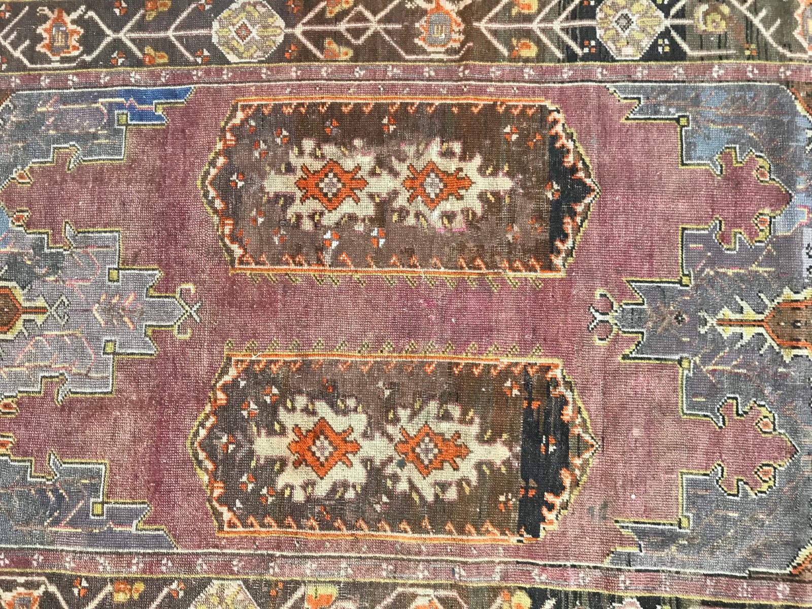 Beautiful early 20th century Turkish Anatolian rug, with beautiful Geometrical double Mihrab design, and nice natural colors with purple, pink, yellow, green and orange, entirely hand knotted with wool velvet on wool foundation.