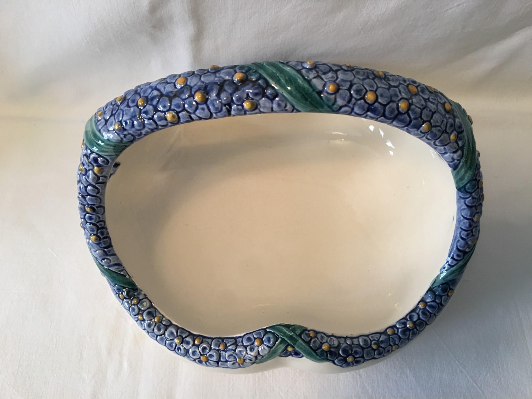 This beautiful ceramic flower basket was created by Karlsruhe Majolika sometime between 1911 and 1930. It was designed by Max Heinze in 1911. It is a great way to present Bonbons or Business cards or a variety of items in any environment. No damages.