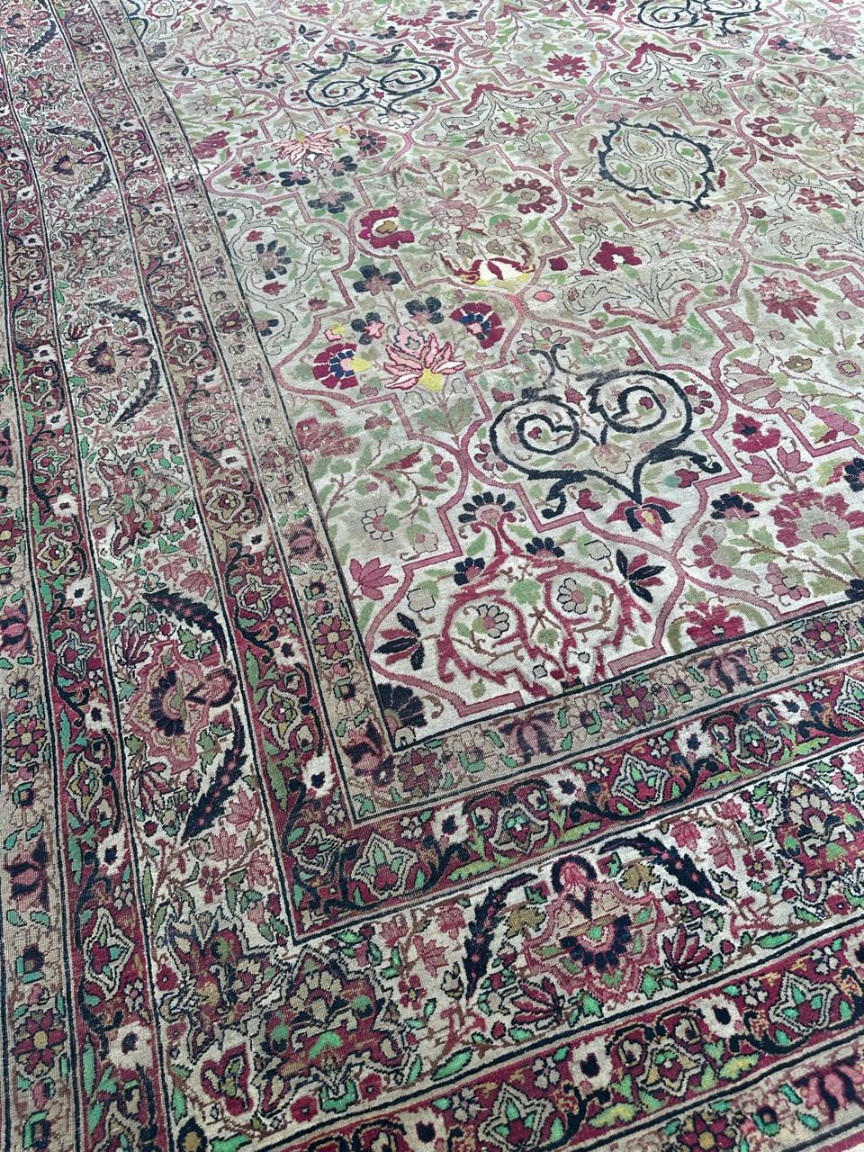 Discover the allure of our very beautiful large antique Kirman rug. Adorned with an enchanting stylized floral design and boasting a palette of lovely natural colors, this rug is a true masterpiece. Meticulously hand-knotted with wool velvet on a