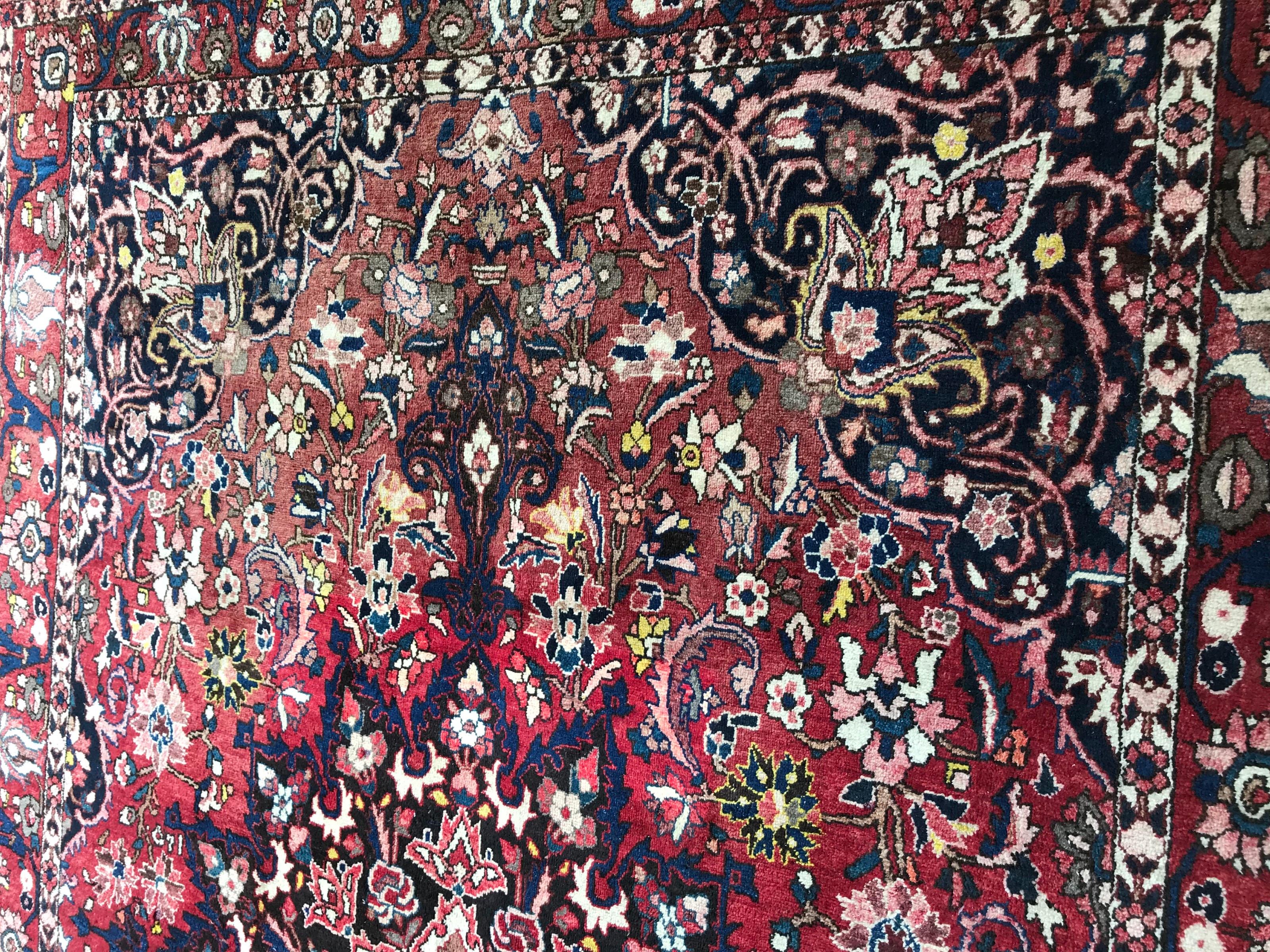 Beautiful mid-20th century rug with a decorative floral design and a beautiful central medallion and nice colors with blue, red, yellow, pink and grey, entirely hand knotted with wool velvet on cotton foundation.