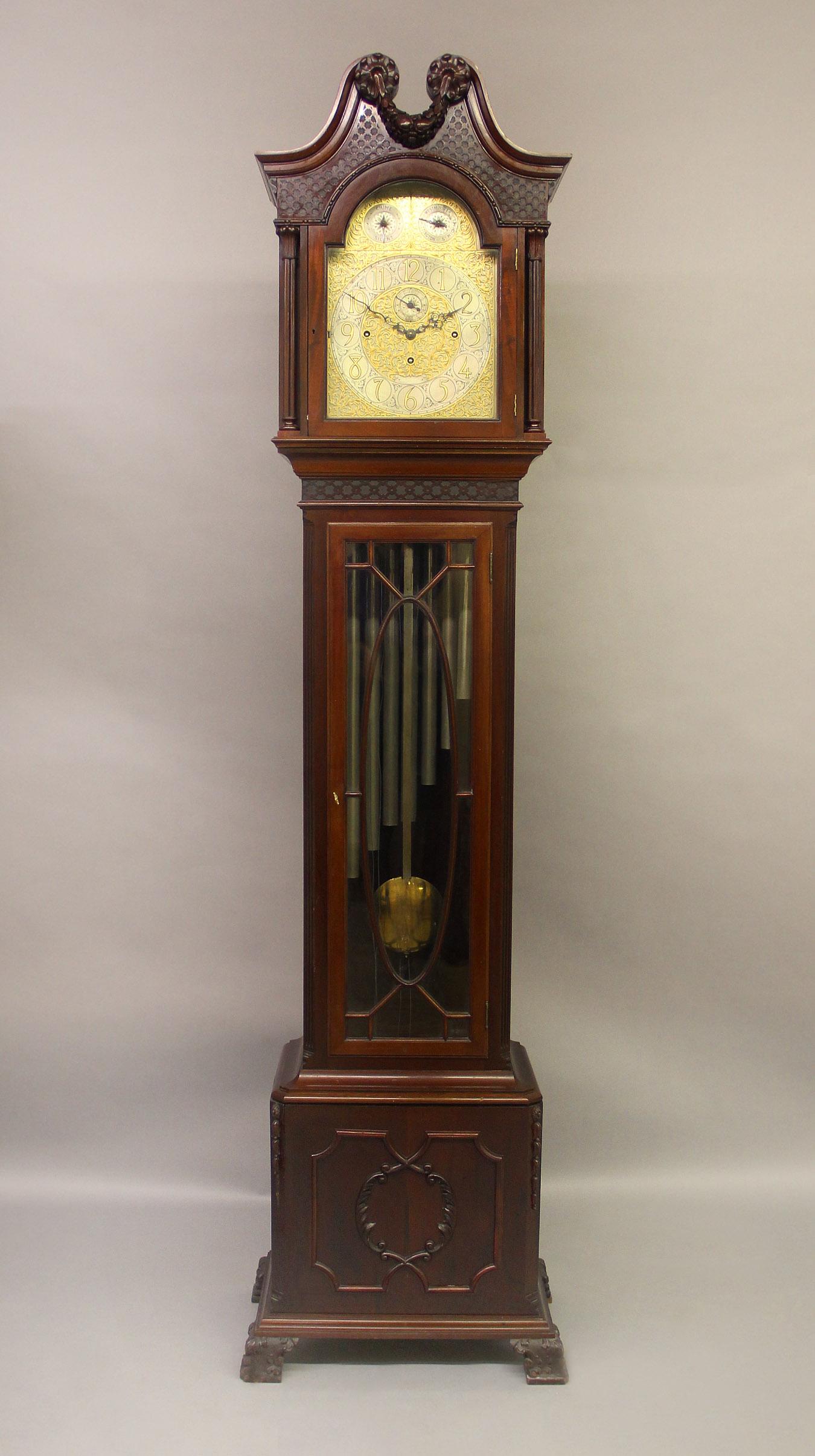 A Nice Late 19th Century English Carved Nine Tube Longcase Grandfather Clock

The clock with an eight day movement and chiming on nine tubes. The very elaborate designed face with Arabic Numerals enclosing a subsidiary seconds dial in the center, a