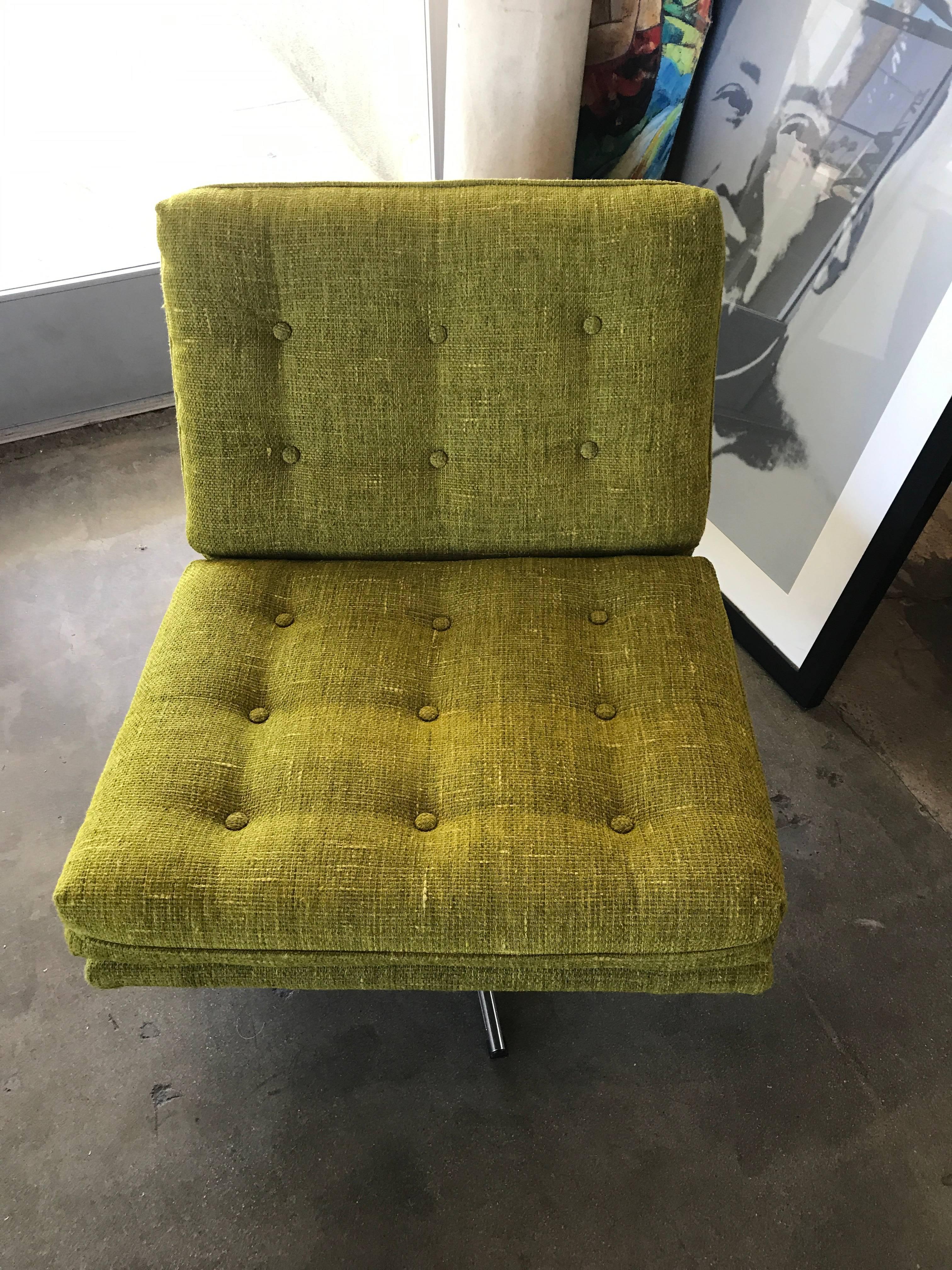 A nice lounge chair that swivels in a nice nubby citrus colored fabric. Recently reupholstered, but has a minor bit of fraying at some edges, which are pictured.
