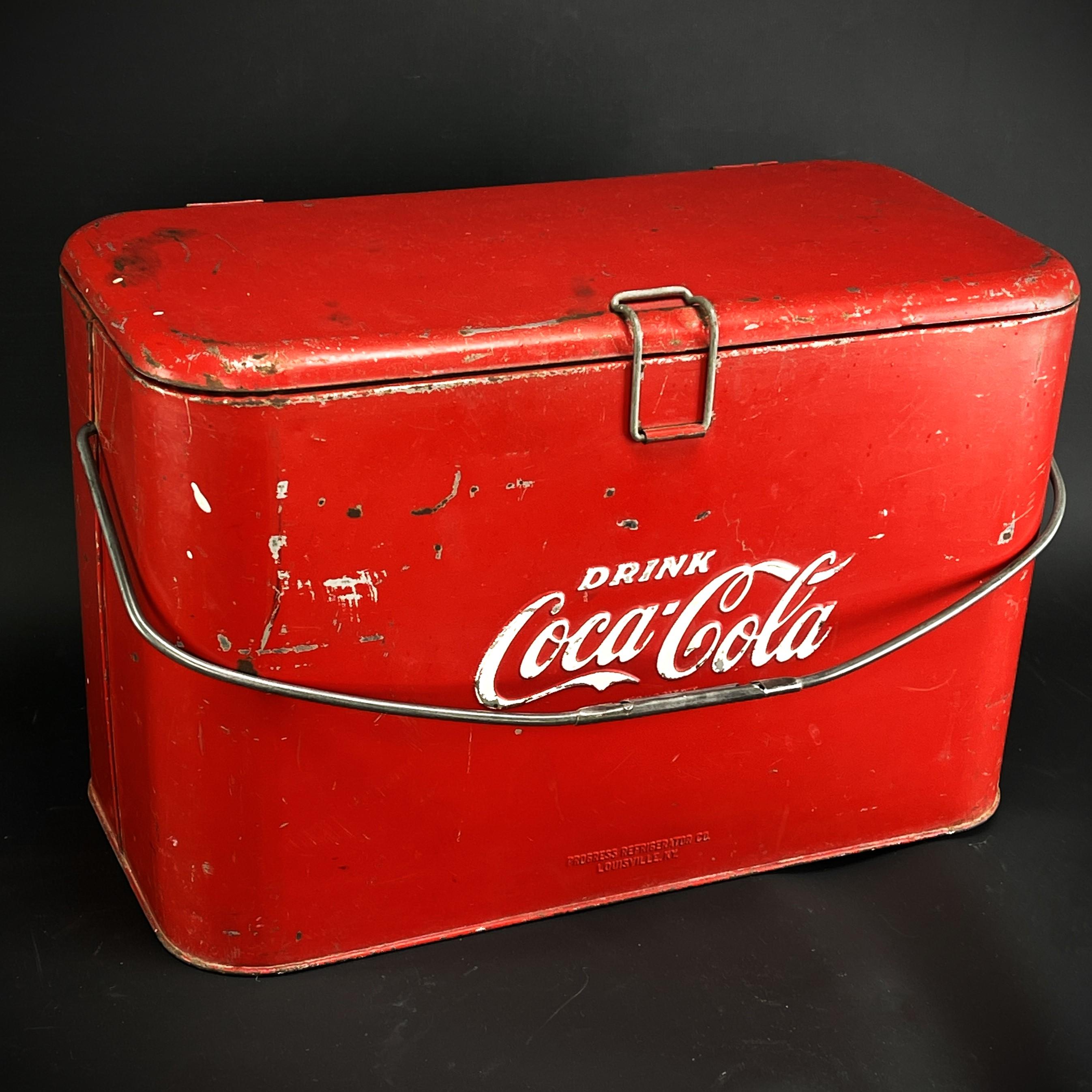 Mid Century Coca Cola cooler beverage crate red Ice Cooler, 50s

The decorative Coca Cola cooler/beverage crate still has the original red painting with white Coca Cola advertising print “Drink Coca-Cola” and “things go better with Coke”. 

The red