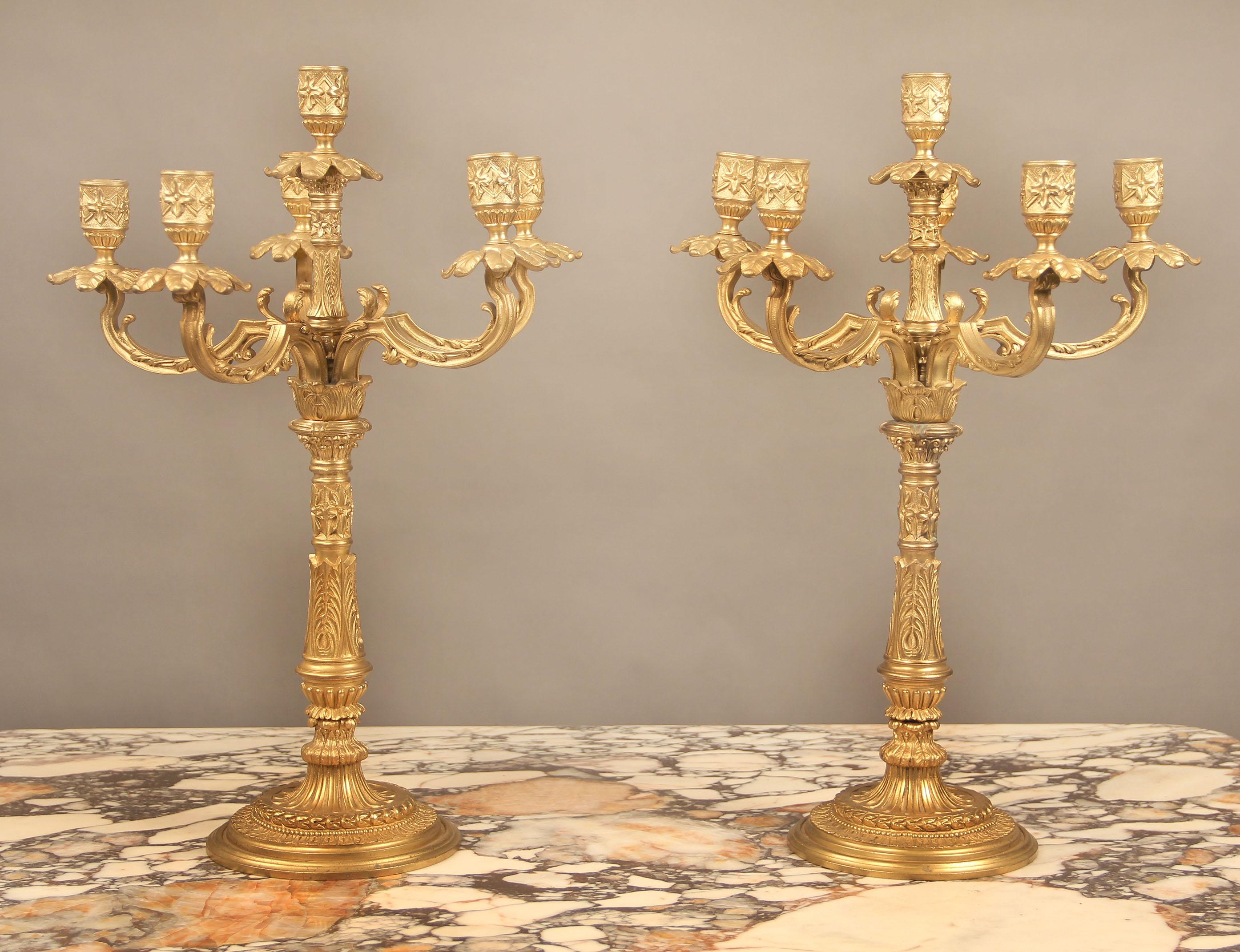 A nice pair of late 19th century gilt bronze six light candelabra

Each with finely designed bodies and round bases, issuing five scrolling branches and a central stem.