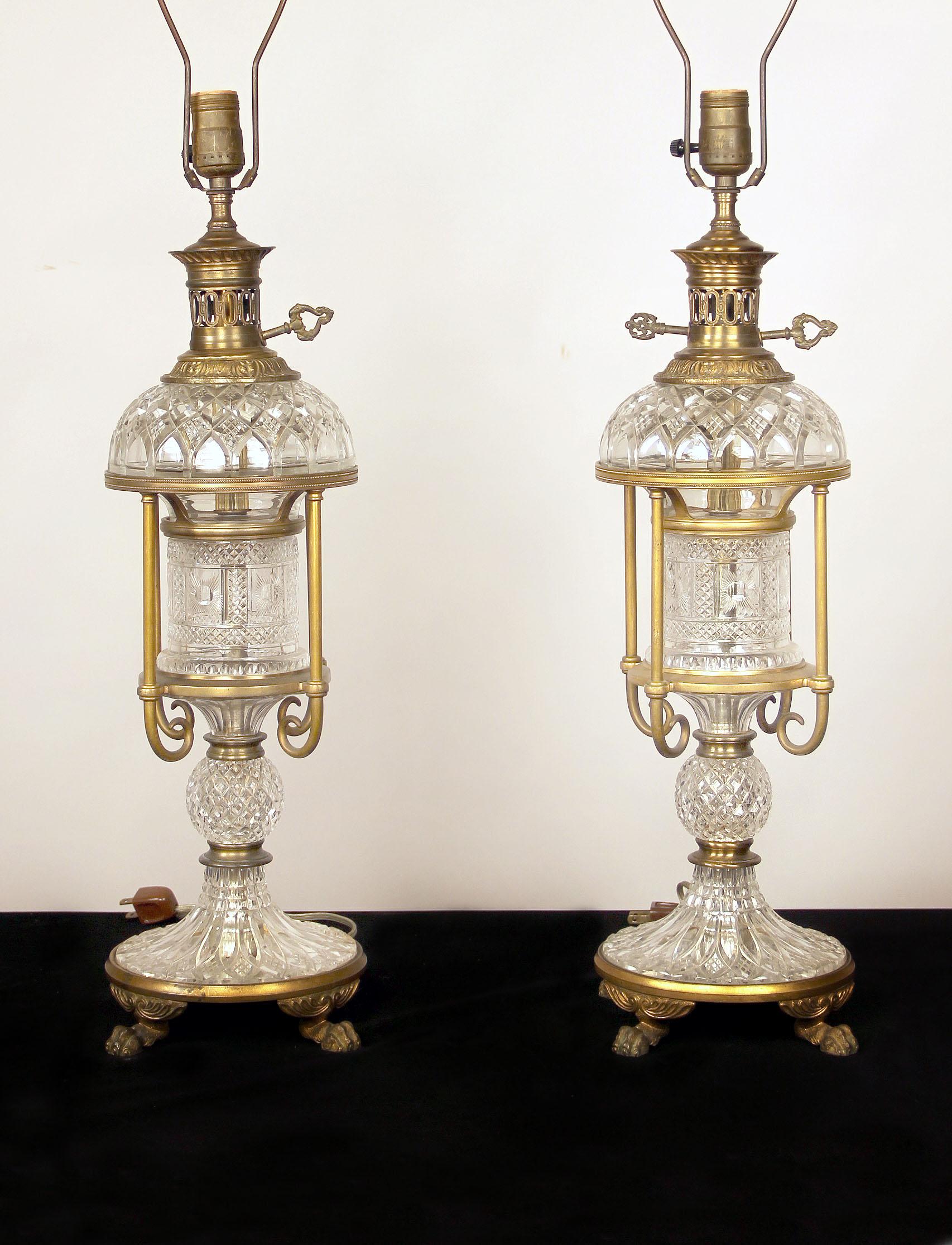 A nice pair of late 19th-early 20th century gilt bronze and French crystal lamps

Fine cut crystal bodies with bronze mounts standing on lion paw feet.
 