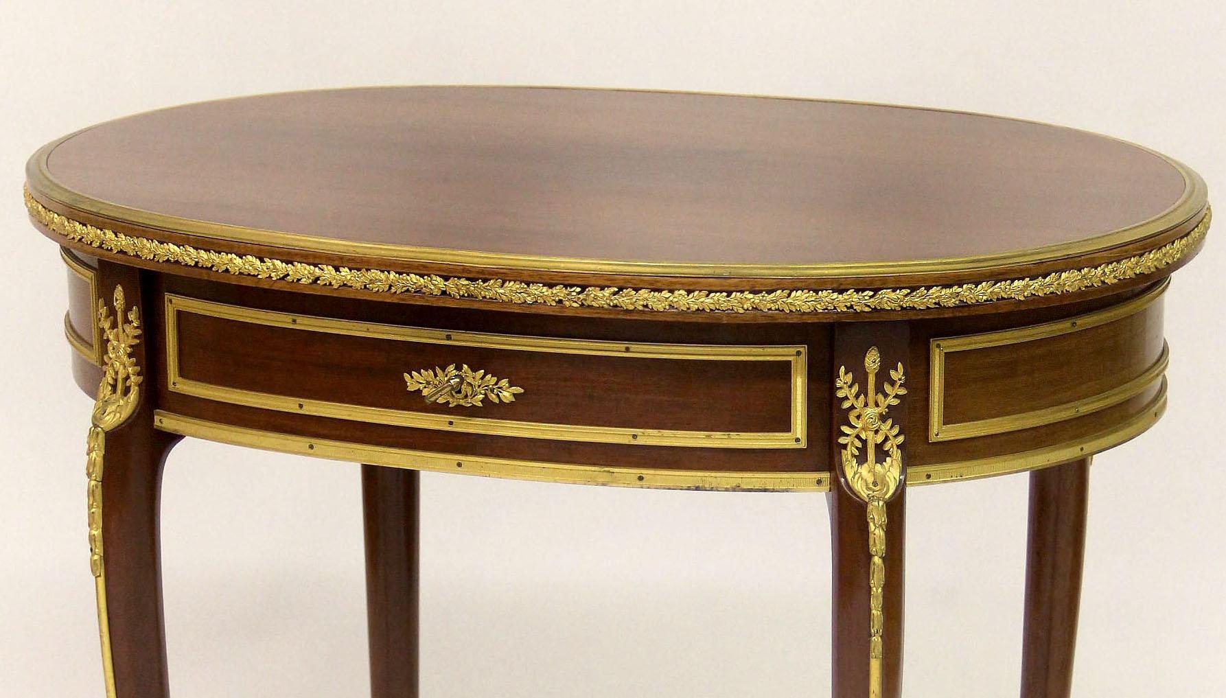 A nice quality late 19th century gilt bronze-mounted Louis XV style side table

An oval wood top over a single long, center drawer, raised on cabriole legs.