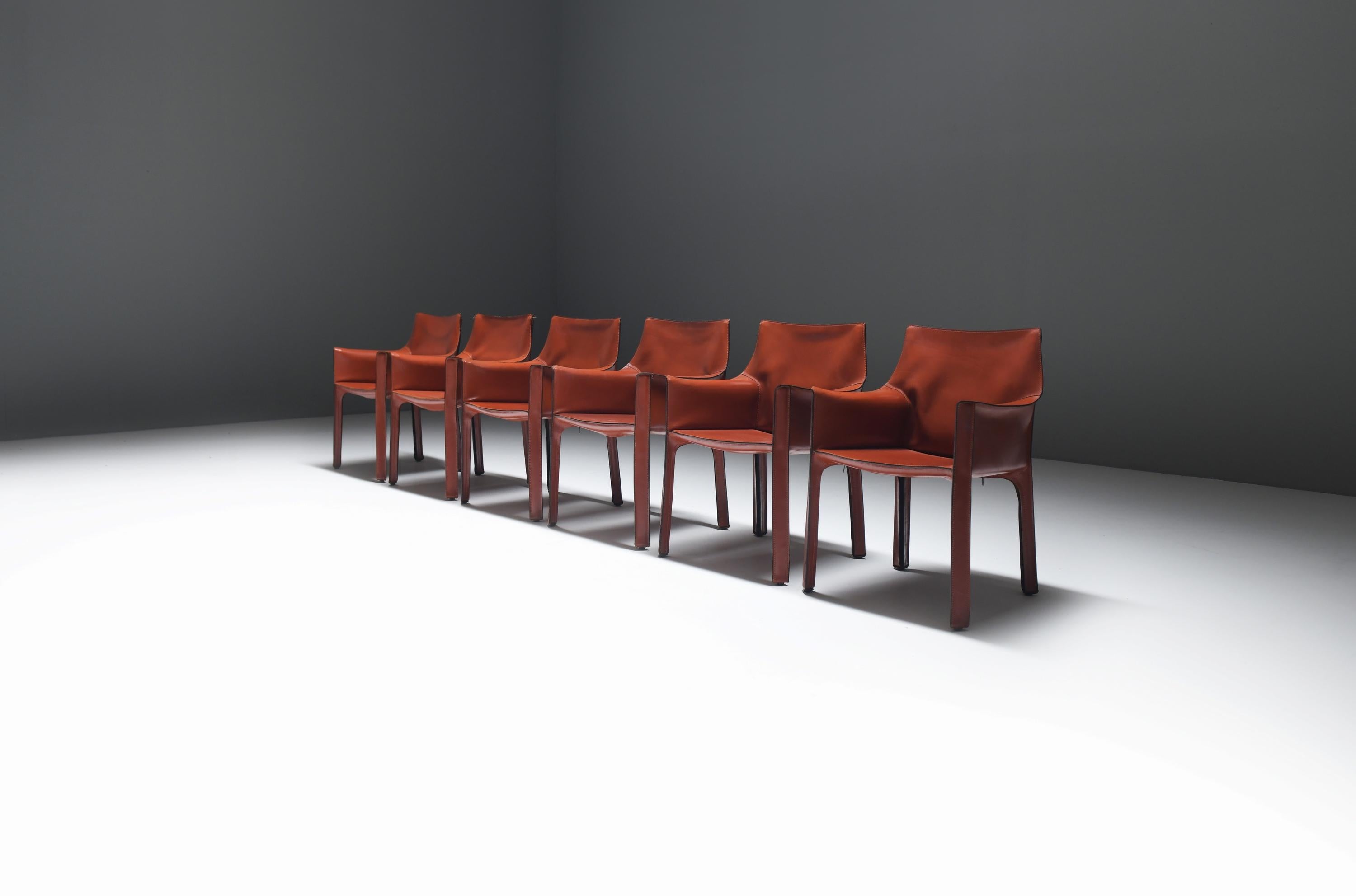 Nice set of the iconic Cab 413 dining chairs in burgundy leather.  Extremely comfortable and beautiful armchairs! 
Designed by Mario Bellini for CASSINA.

The CAB chairs were designed by Mario Bellini in 1979. Conceptually new was the way Bellini