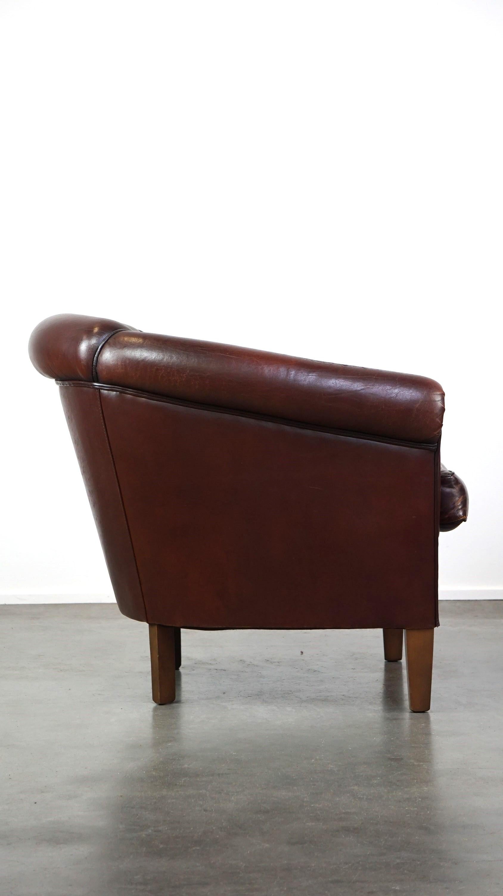 Hand-Crafted Nice sheepskin club chair with a beautiful patina For Sale