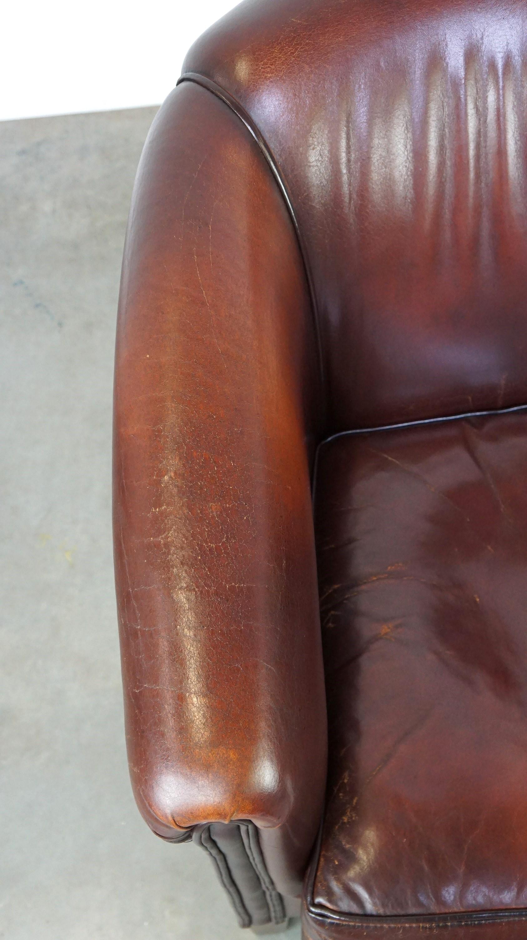 Nice sheepskin club chair with a beautiful patina For Sale 1