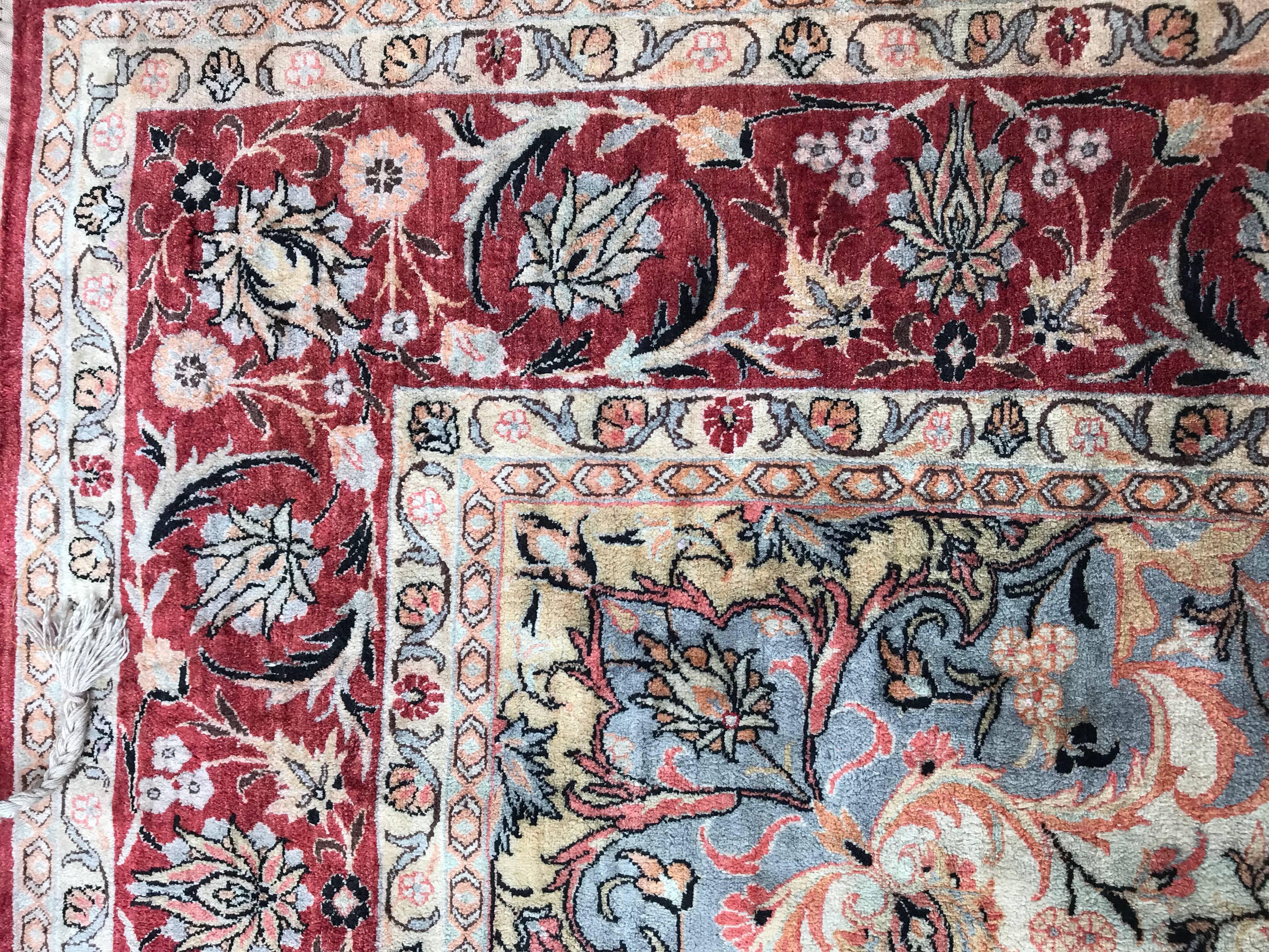 Very beautiful and fine contemporary silk rug in style of Persian Ispahan rugs, with nice floral central medallion design and light colors with red, light blue, pink, yellow and orange, entirely and finely hand knotted with silk velvet on silk