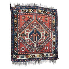 Beau tapis Qashqai ancien face à petit sac